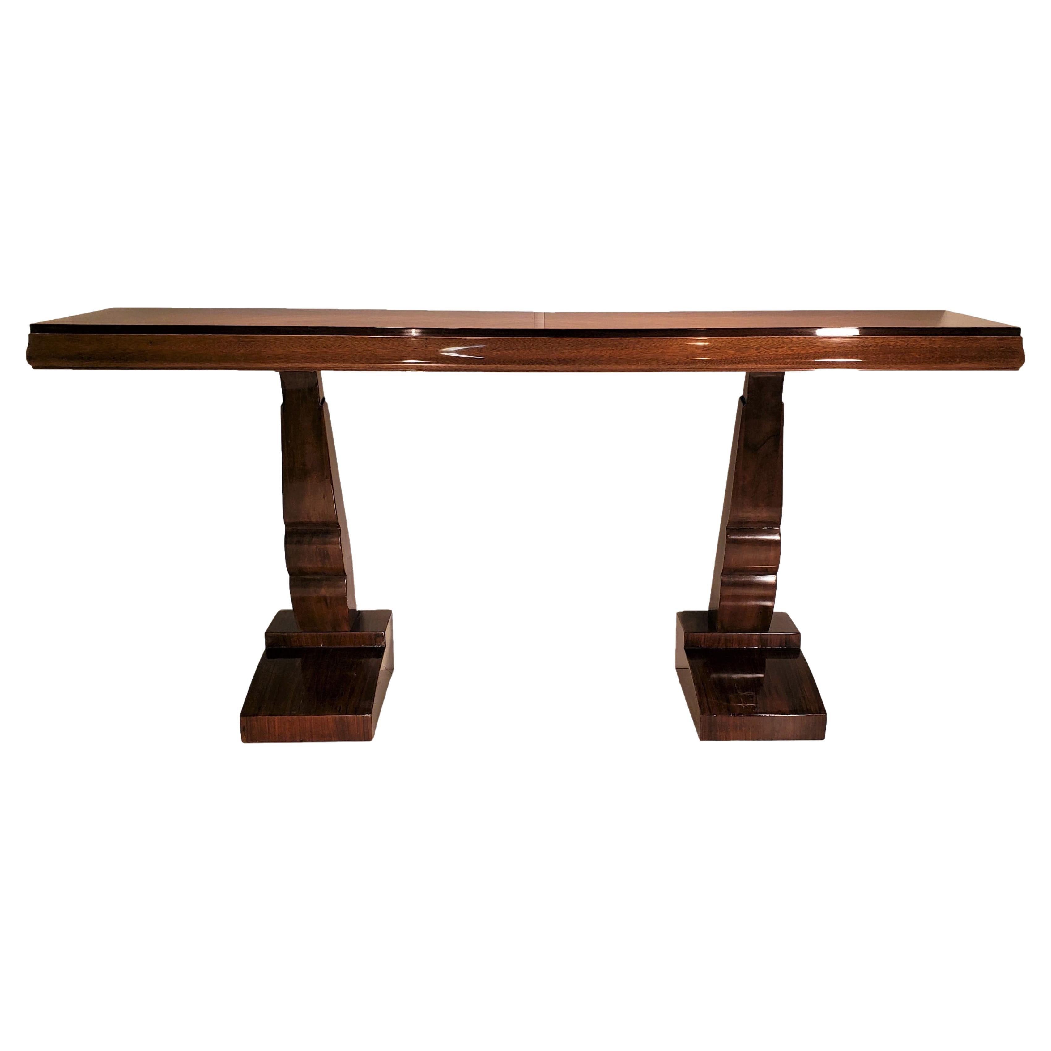 An elegant, original French Modern parquetry inlaid multi wood console in in figured rosewood, walnut, and palisander, featuring double sculptural legs raised on stepped and flanged pediment bases.
Paquebot style in a semi gloss lacquer finish with