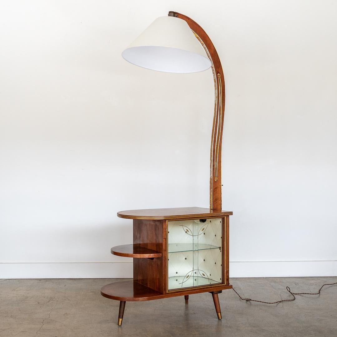Spectacular Art Deco dry bar floor lamp from France, 1930's. Wood arm overhanging lamp and light inside cabinet with original pushbutton switches. An elegant piece, with simple lines and geometric shapes. Glass case with a glass shelf and original