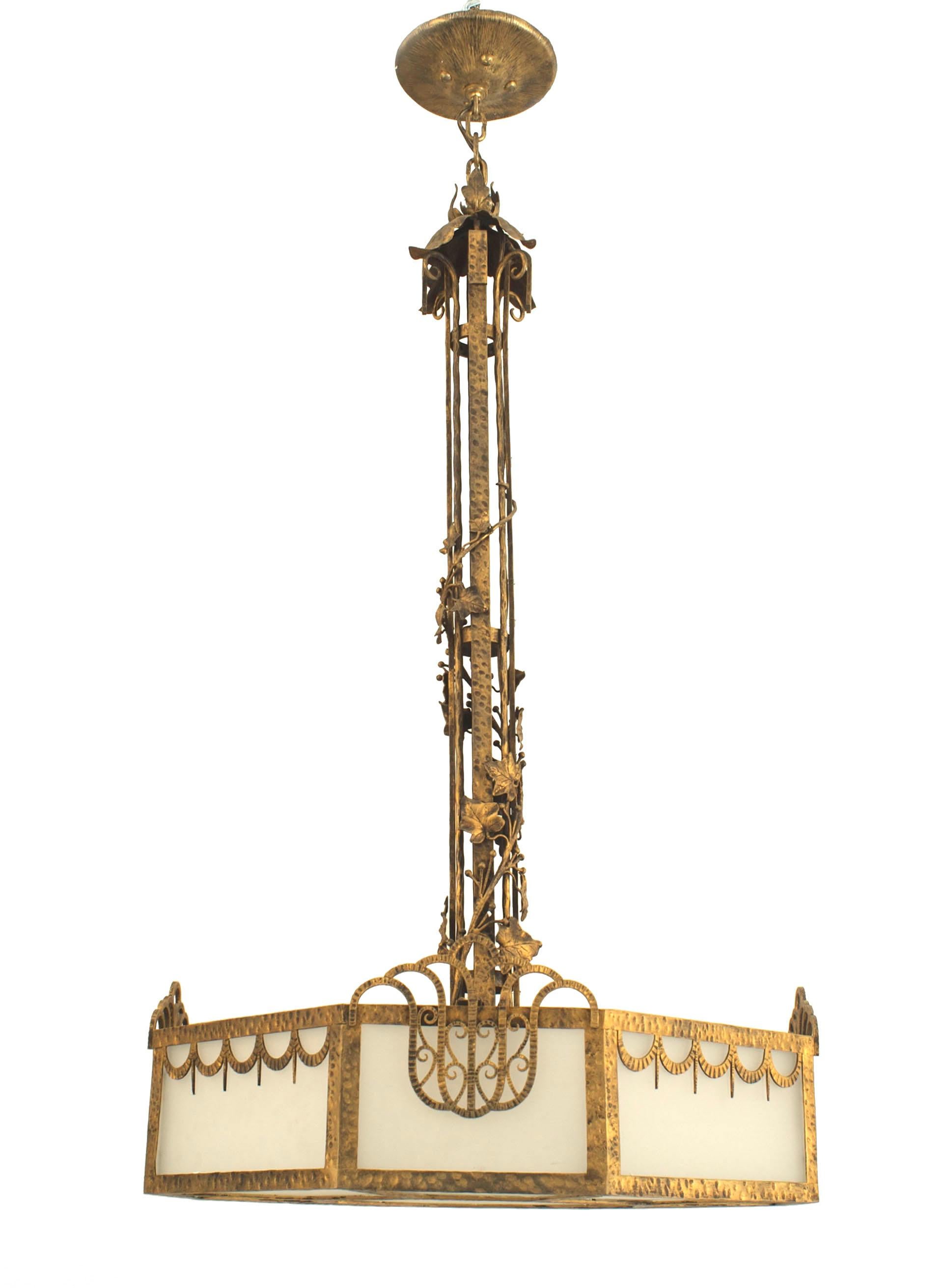 French Art Deco 8 sided chandelier with a hand-hammered and gilded iron frame having a swag and geometric design surrounding milk glass panels with a center shaft wrapped in ivy.
  