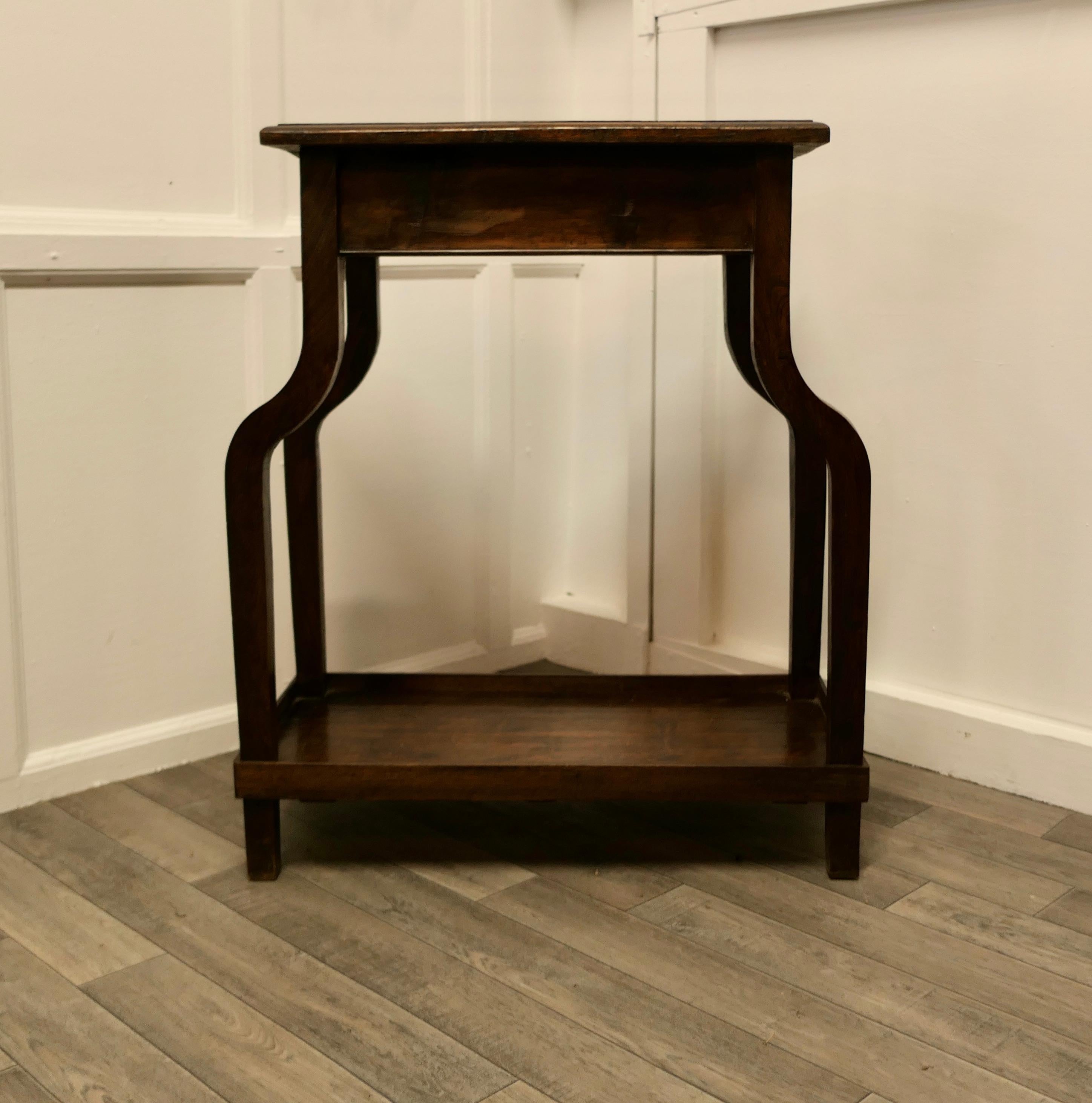 French Art Deco elm table.

A stylish table from France, the table has a rectangular top and a galleried undertier. 
The table legs splay out slightly and then stand straight.
The table is in good condition, the elm top has a good natural