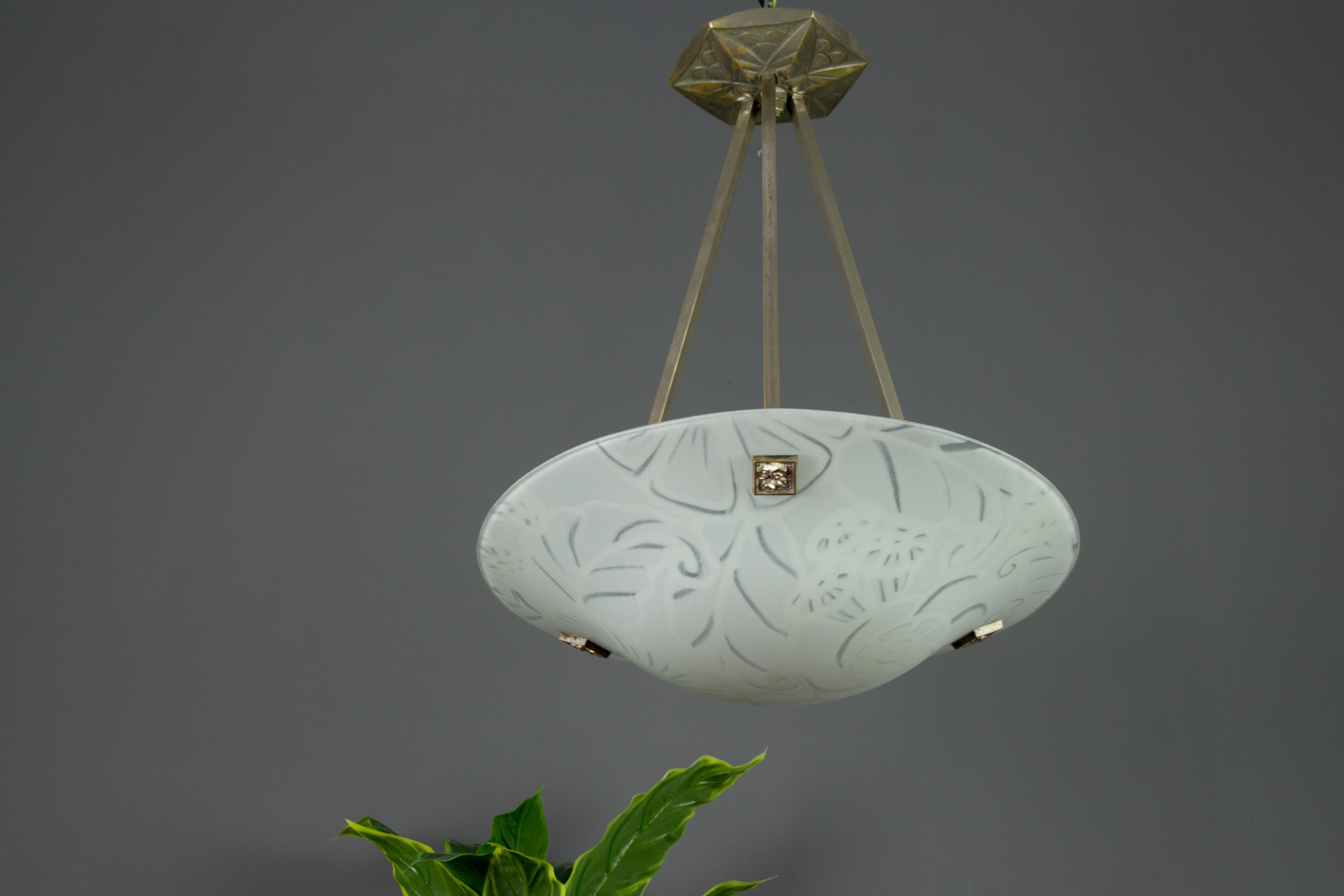 A charming Art Deco pendant light by Maxonade Verrier D’Art, Paris, with stylized floral pattern decoration. The drawing is hand painted and made using enamel paint with a very elaborated technique, signed 'Maxonade Paris'. Hung at a nickel-plated