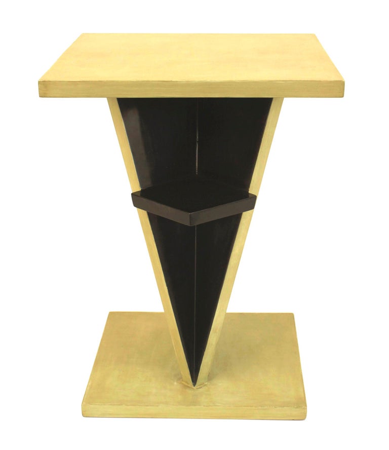 French Art Deco ebonized and light green lacquered end table with a geometric design pedestal base having a small shelf and a square top and base. (Attributed to JEAN DUNAND)
