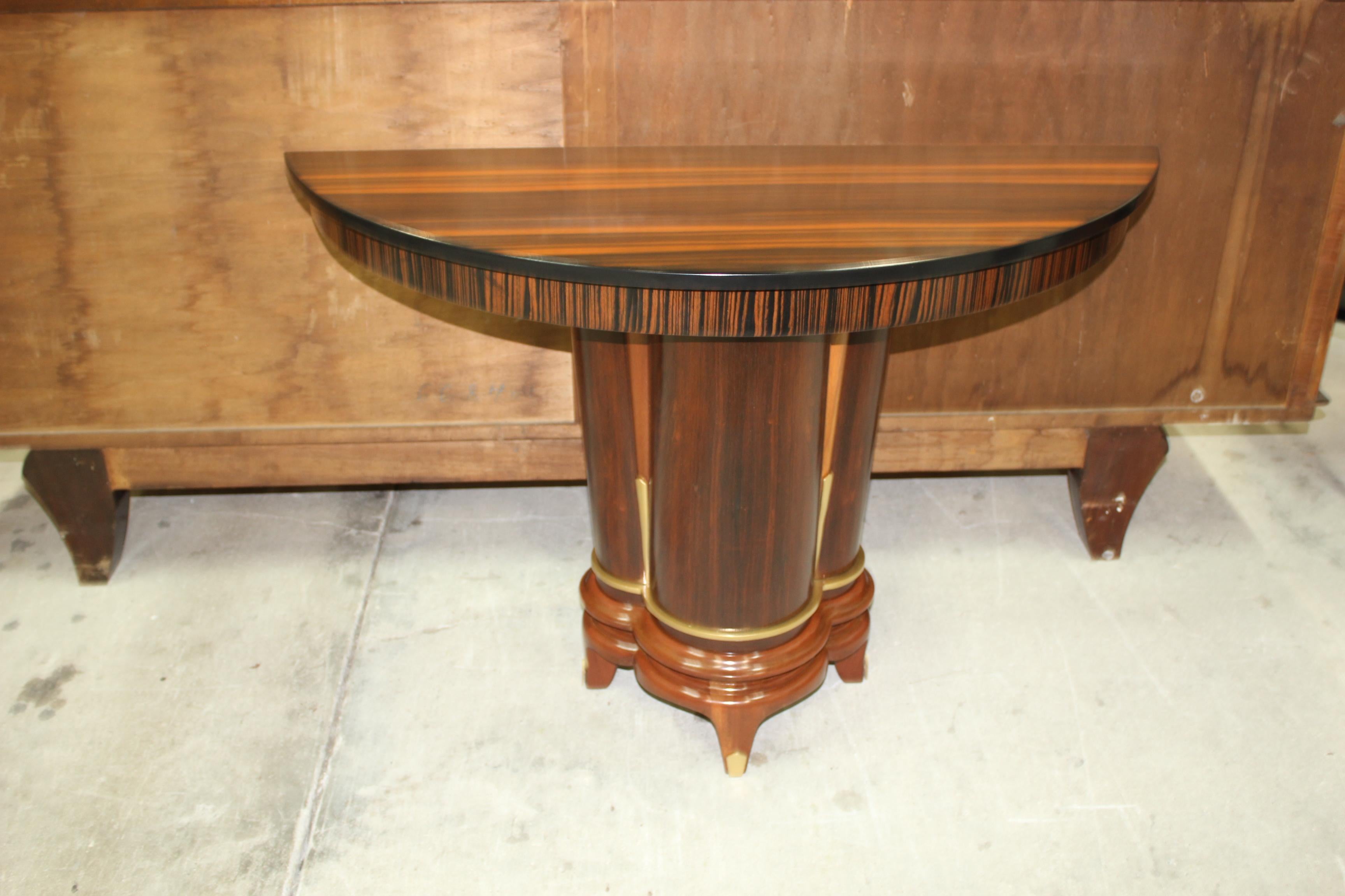 Classic French Art Deco exotic Macassar ebony console tables, circa 1940s. Beautiful Macassar ebony with demilune Macassar top and beautiful design centre base, lacquer finish in both side, beautiful bronze hardware detail, finish in both side,