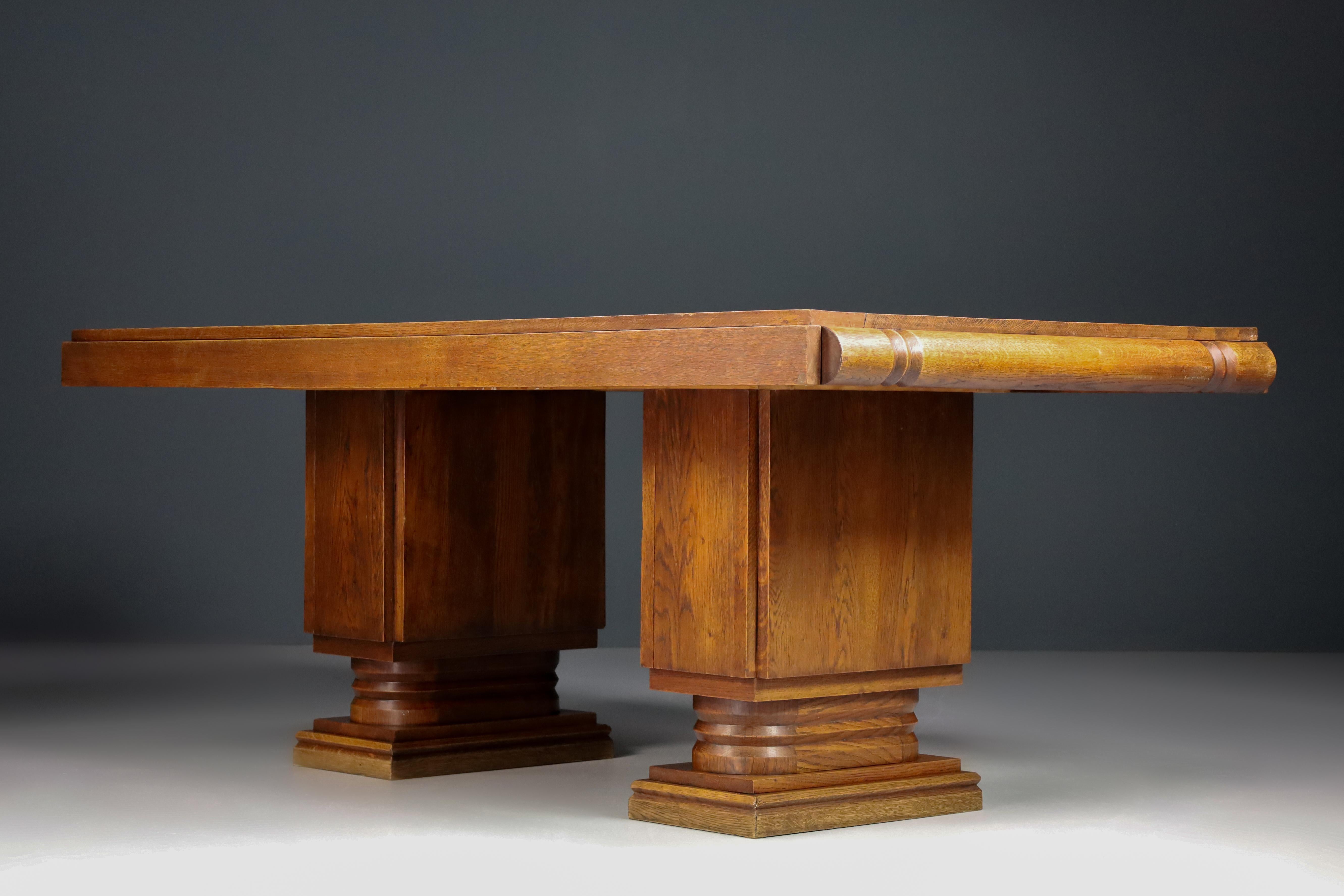 Art Deco extendable table in oak by Charles Dudouyt, France 1940s.

This stunning extendable table was crafted in Normandy, France, circa 1940. This extendable (extra 100cm) dining table made in oak is sure to add an element of French brutalism to