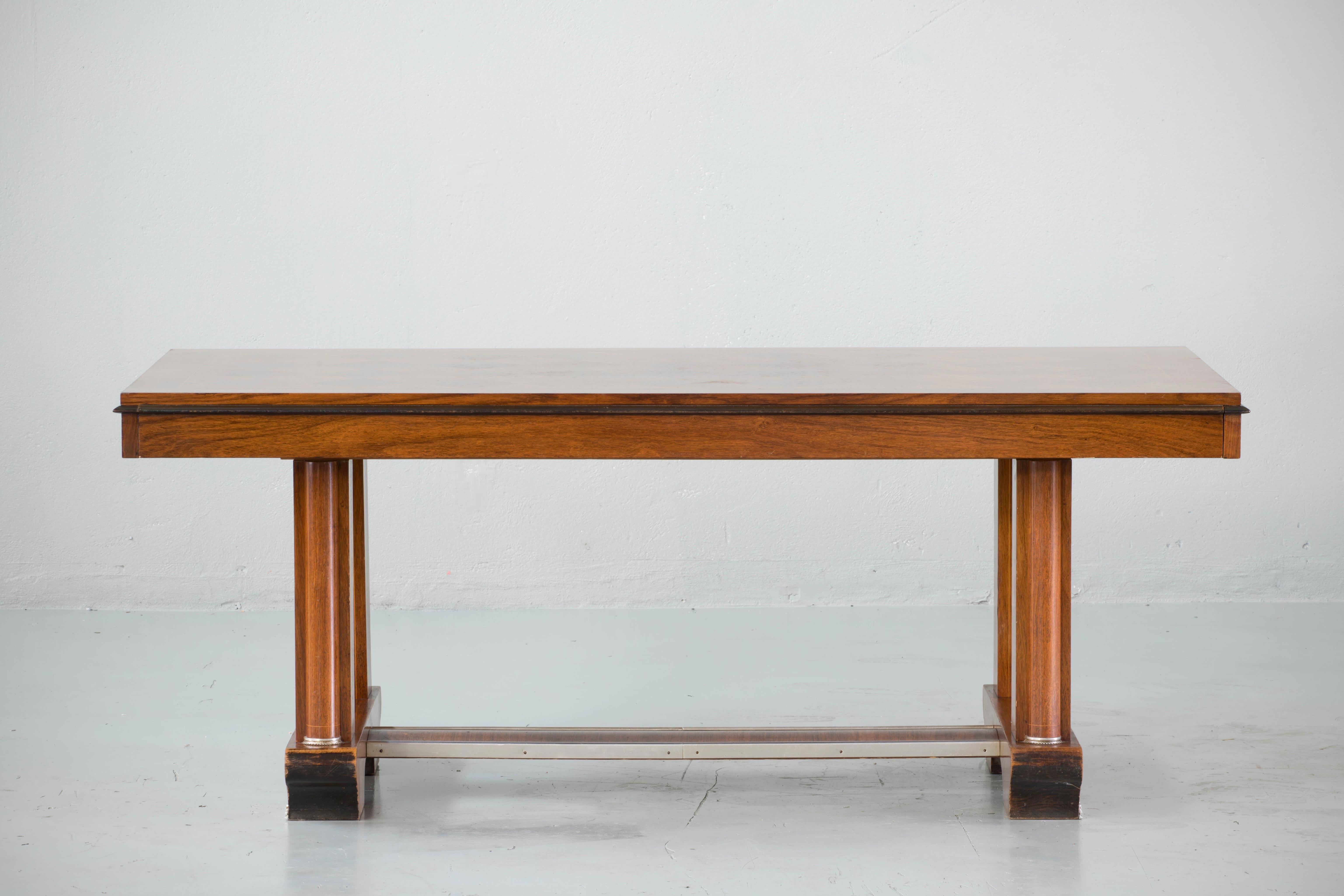 French Art Deco dining table or library table, circa 1940s. It is a versatile size and can be used as a dining table, library table, or large scale partners desk or bureau plat.
The table can be extended from each side, the extensions are 33 cm