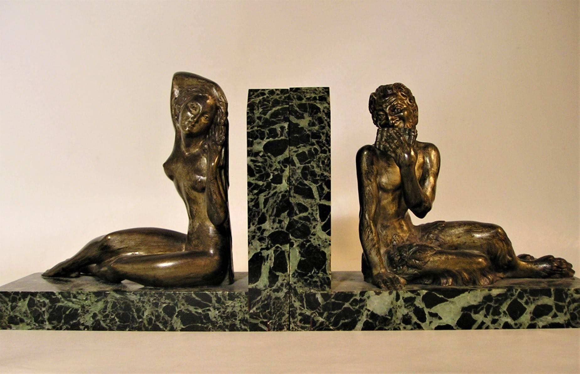 French Art Deco figural bookends with marble and Greek mythological figures. They feature pan and Aphrodite.