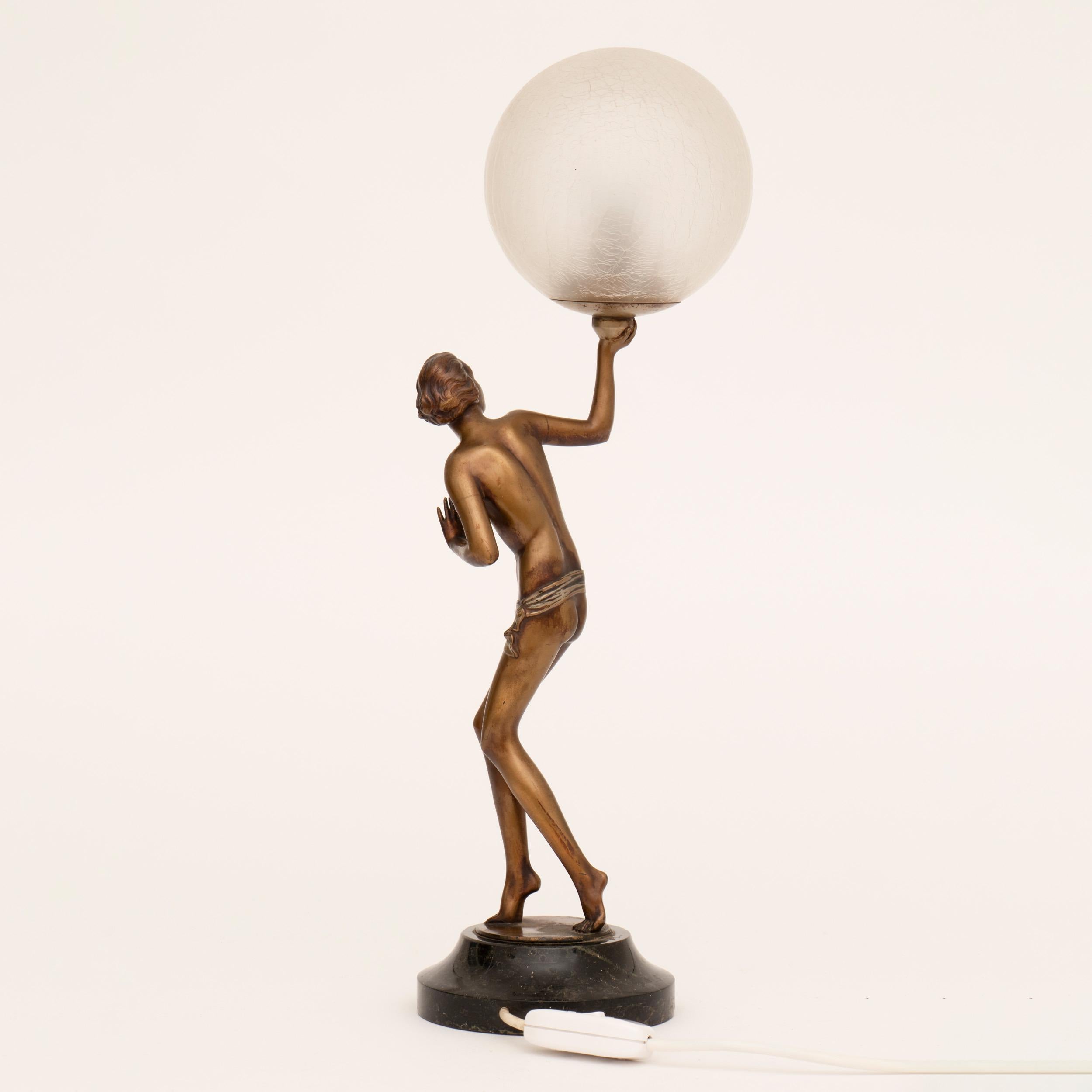Semi nude Art Deco figure lamp holding aloft a crackle glaze illuminating globe, raise on a marble plinth.
A figure by Lorenzl.
Measures: H 57cm, W 19cm, D 13cm
French, circa 1930.