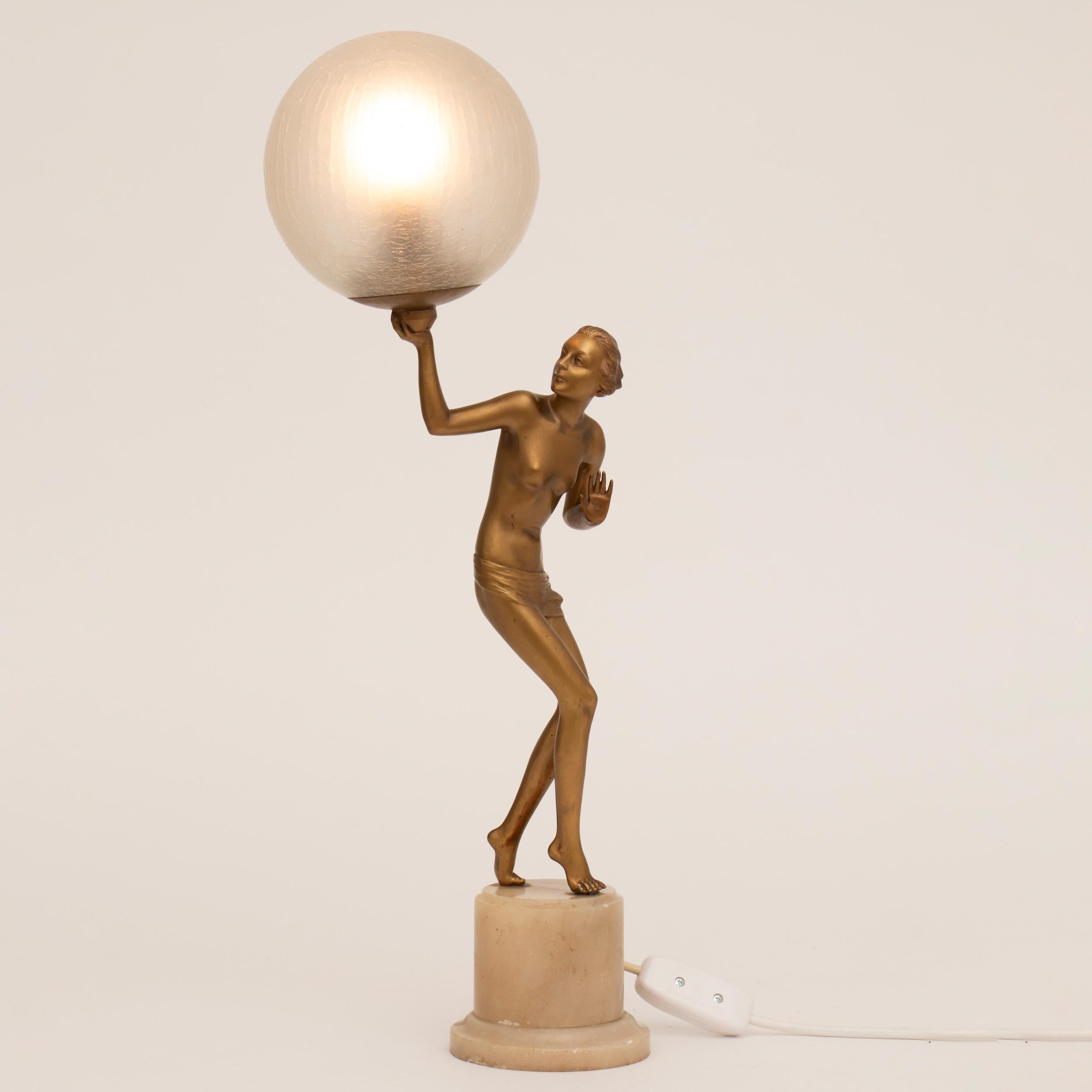 Semi nude Art Deco figure lamp holding aloft a crackle glaze illuminating globe, raise on a marble plinth.
A figure by Lorenzl.
Measures: H 60cm W 21cm D 24cm
French circa 1930.