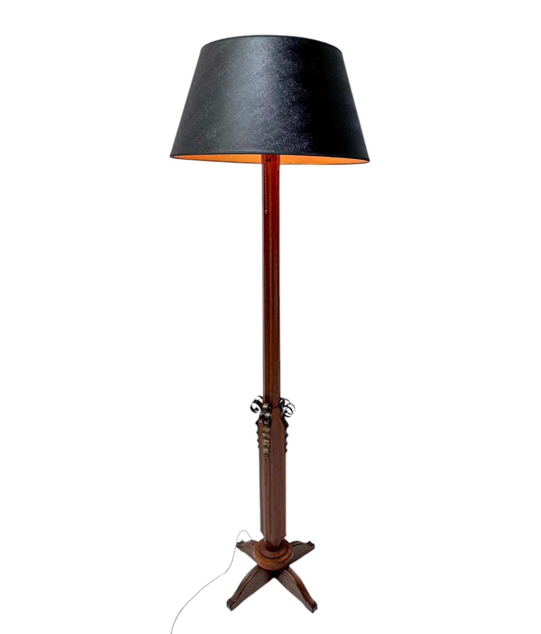 Stunning and elegant Art Deco floor lamp.Striking French design from the 1930s.Solid walnut base with original decorative patinated brass elements.New shade made of black lacquered fabric.Rewired with one socket for E-27 light bulb.This wonderful