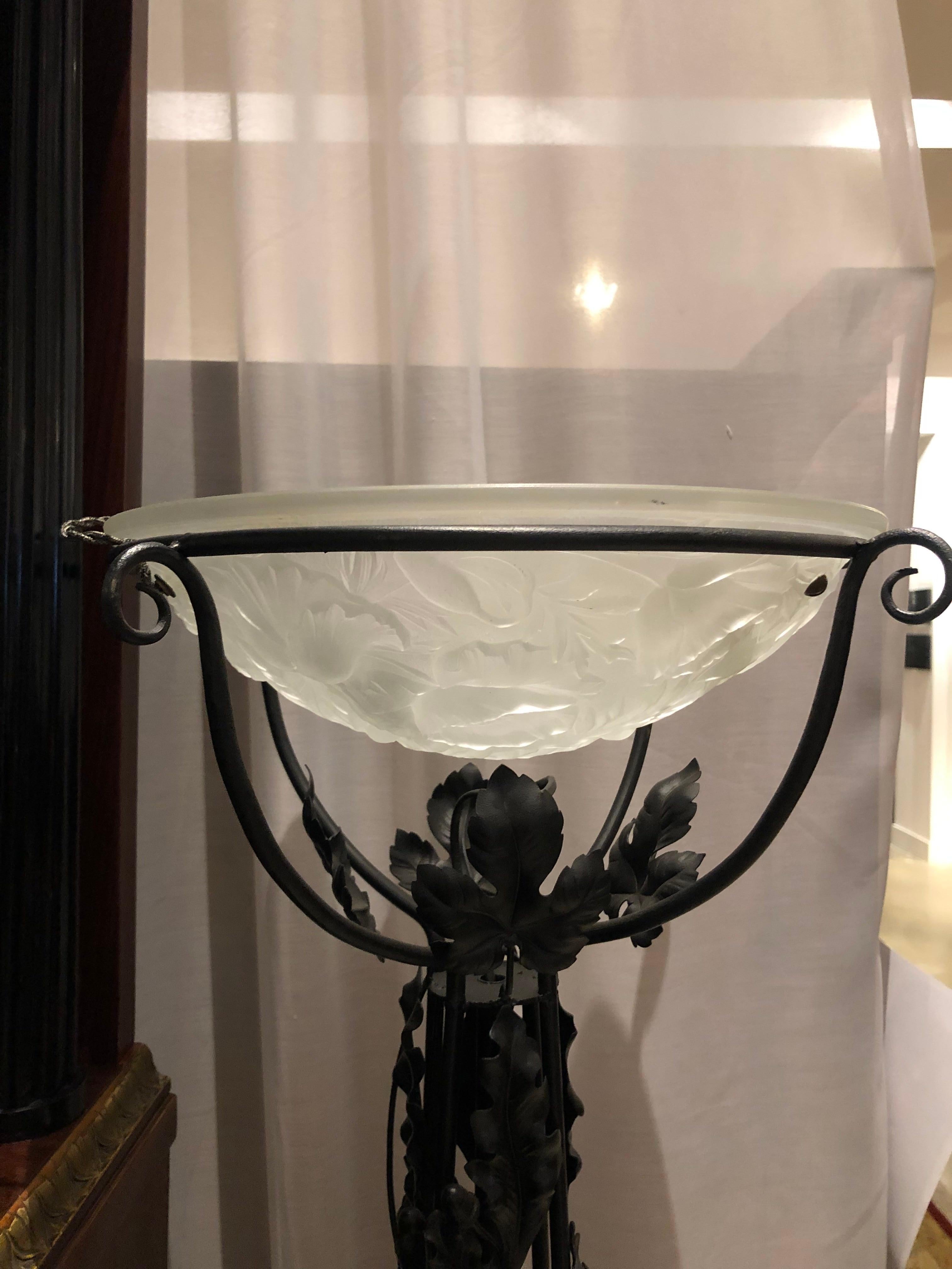 French Art Deco black wrought iron floor lamp with trailing vines and leaves and single frosted glass bowl with leaf pattern.