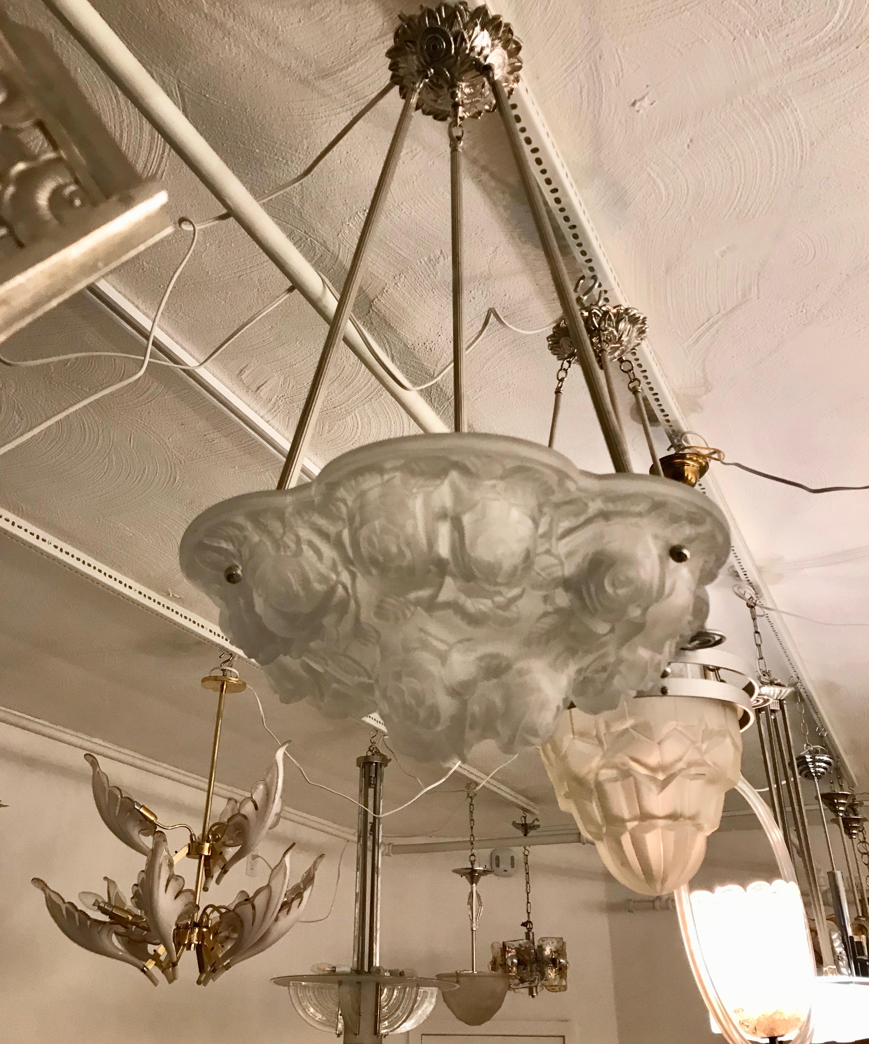 Stunning French Art Deco wall chandelier signed by the French artist Verdun. Molded clear frosted glass shade decorated with floral motif. The shade is marked Verdun. Held by three rods and matching ceiling plate in polished nickel. Has been rewired