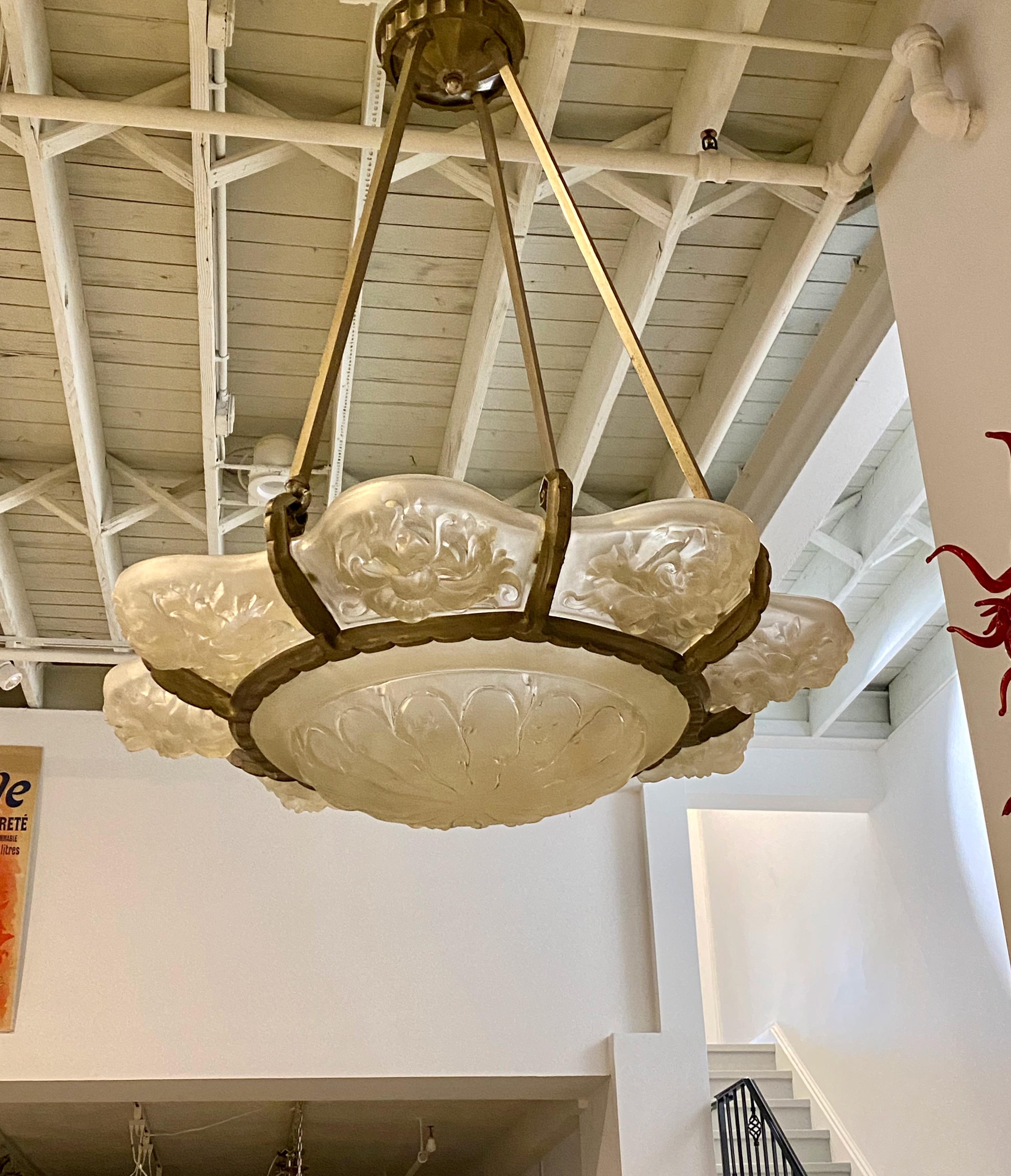 French Art Deco chandelier signed by Marius-Ernesto Sabino. Eight outer frosted glass panels in floral motif with center coupe. Held by a nickel frame with three rods. The frame is in original condition in nickel. Has been re wired for American use