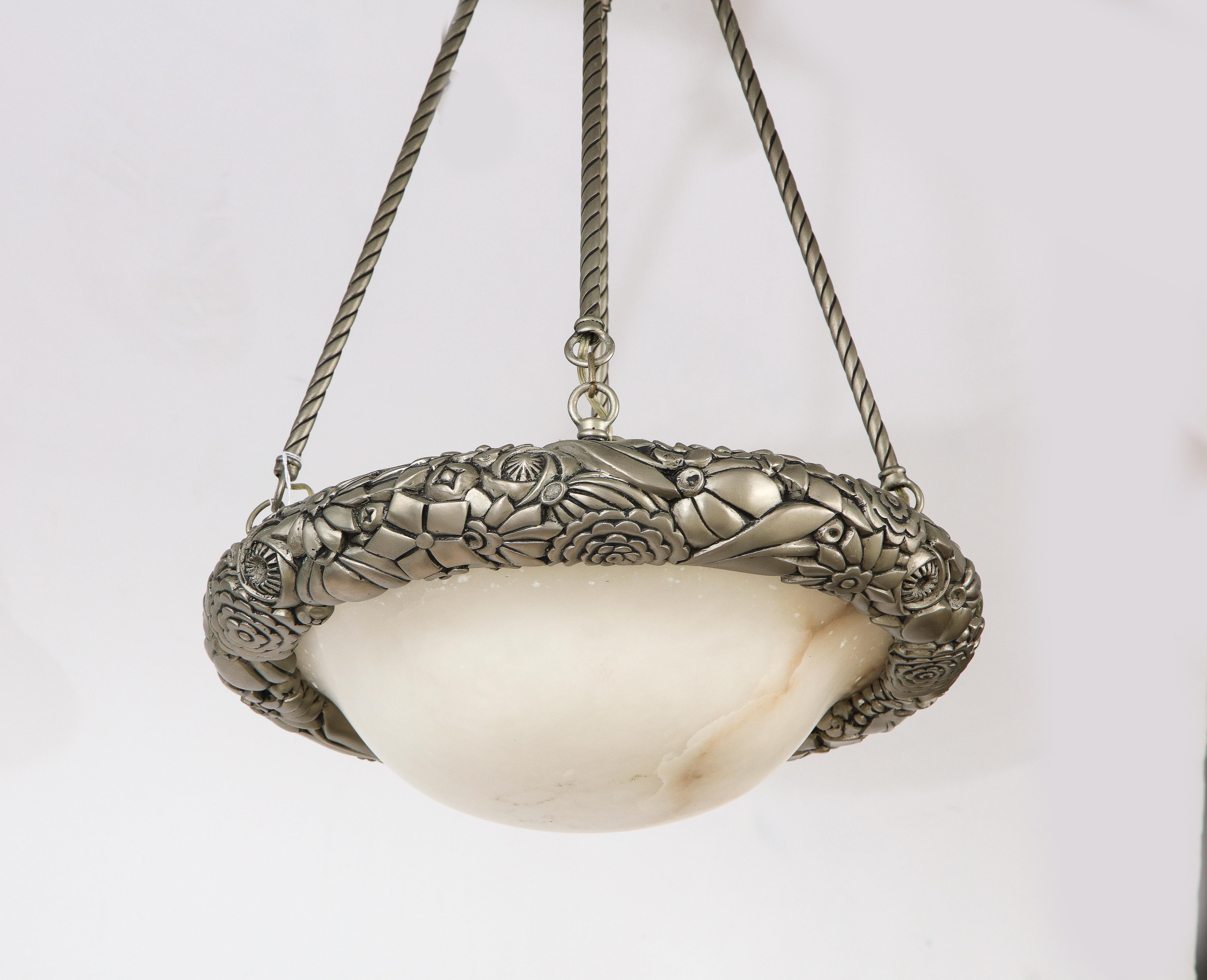 A wonderful French Art Deco pendant chandelier, the alabaster dome shade with silvered metal surround cast with floral motifs, supported by four rope motif rods with smooth canopy, in the manner of Sabino. Measures: 22