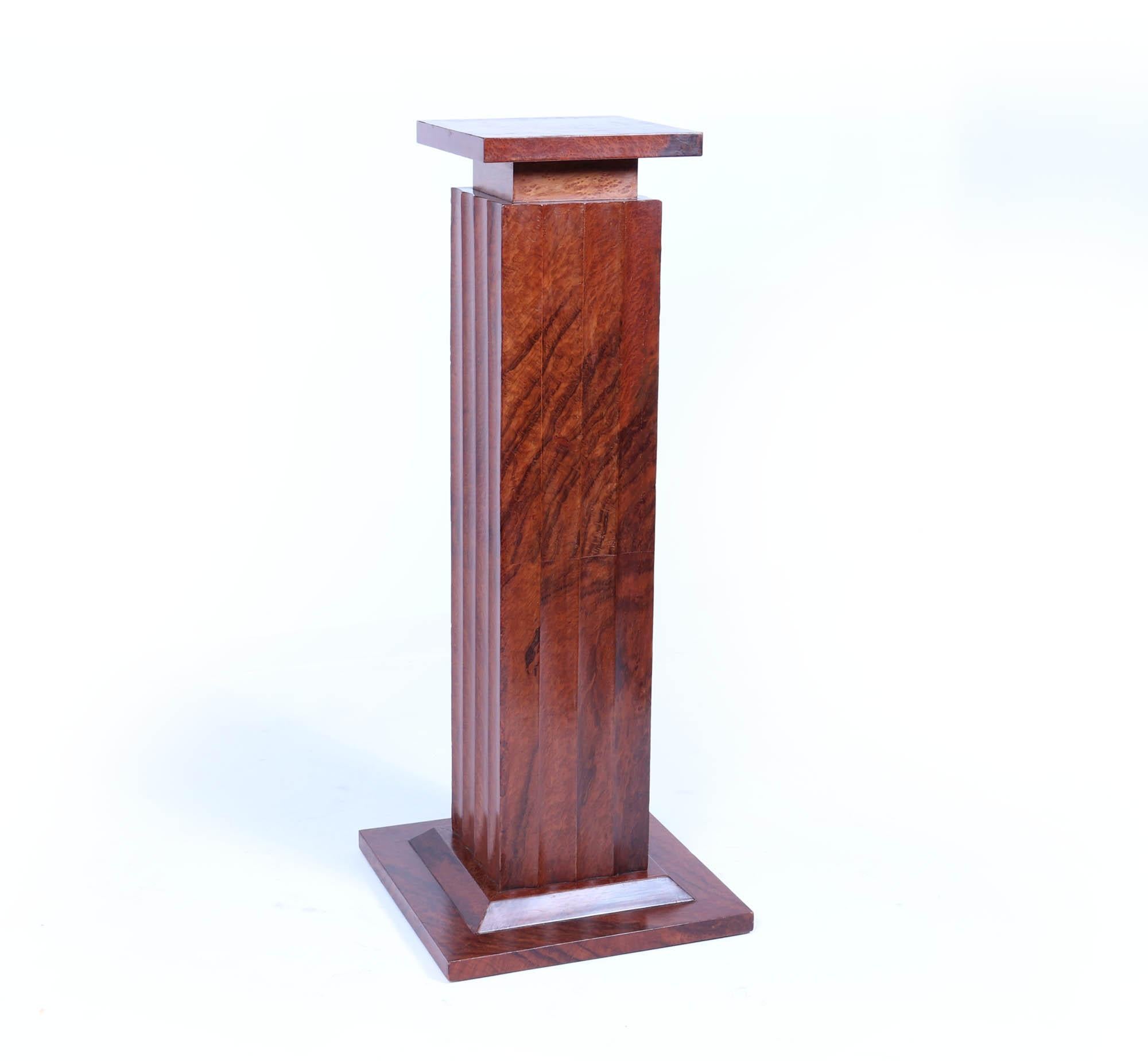 French Art Deco Fluted Thuya Column
A beautiful French Art Deco column pedestal that effortlessly combines elegance and functionality, making it the perfect statement piece for any sophisticated space. Crafted around 1925, this stunning pedestal