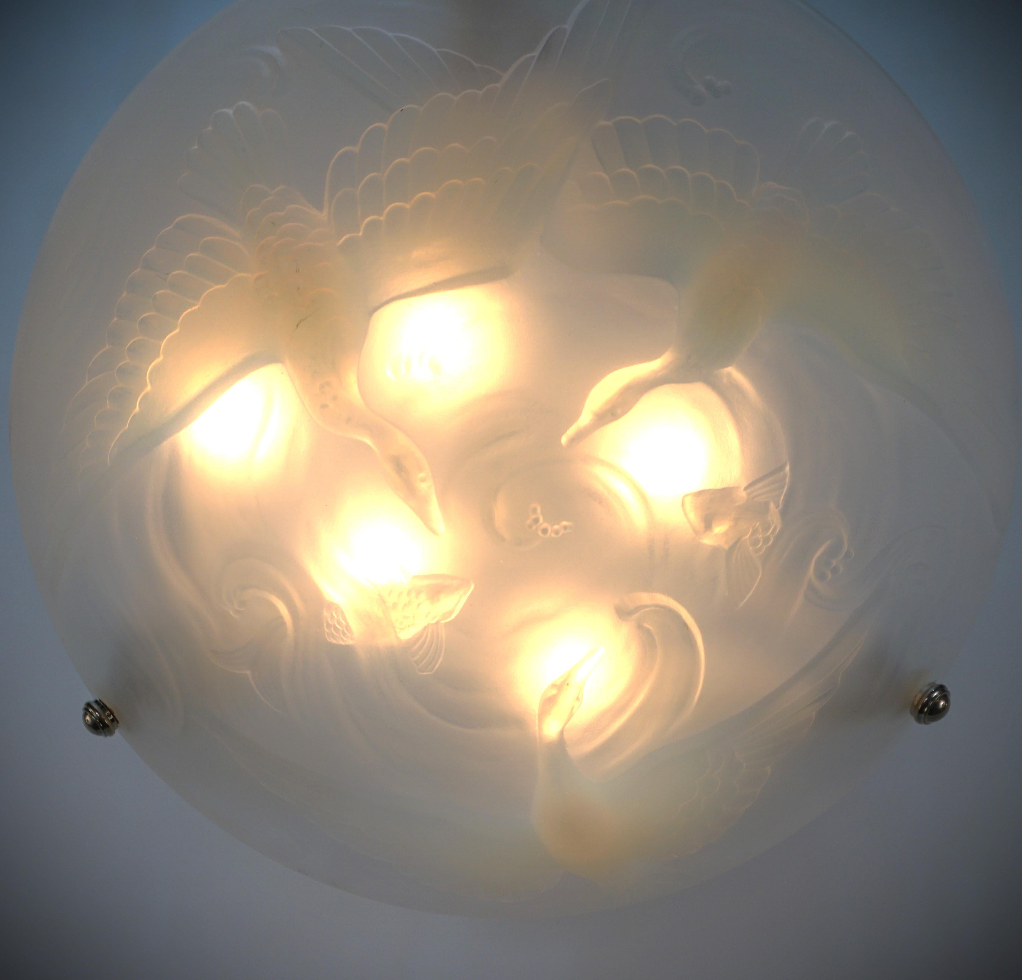 Opaline light color honey blue glass wit flying bird and fish chandelier with nickel on bronze hardware.
Professionally rewired and ready for installation.
  Six lights, 60 watts max each.