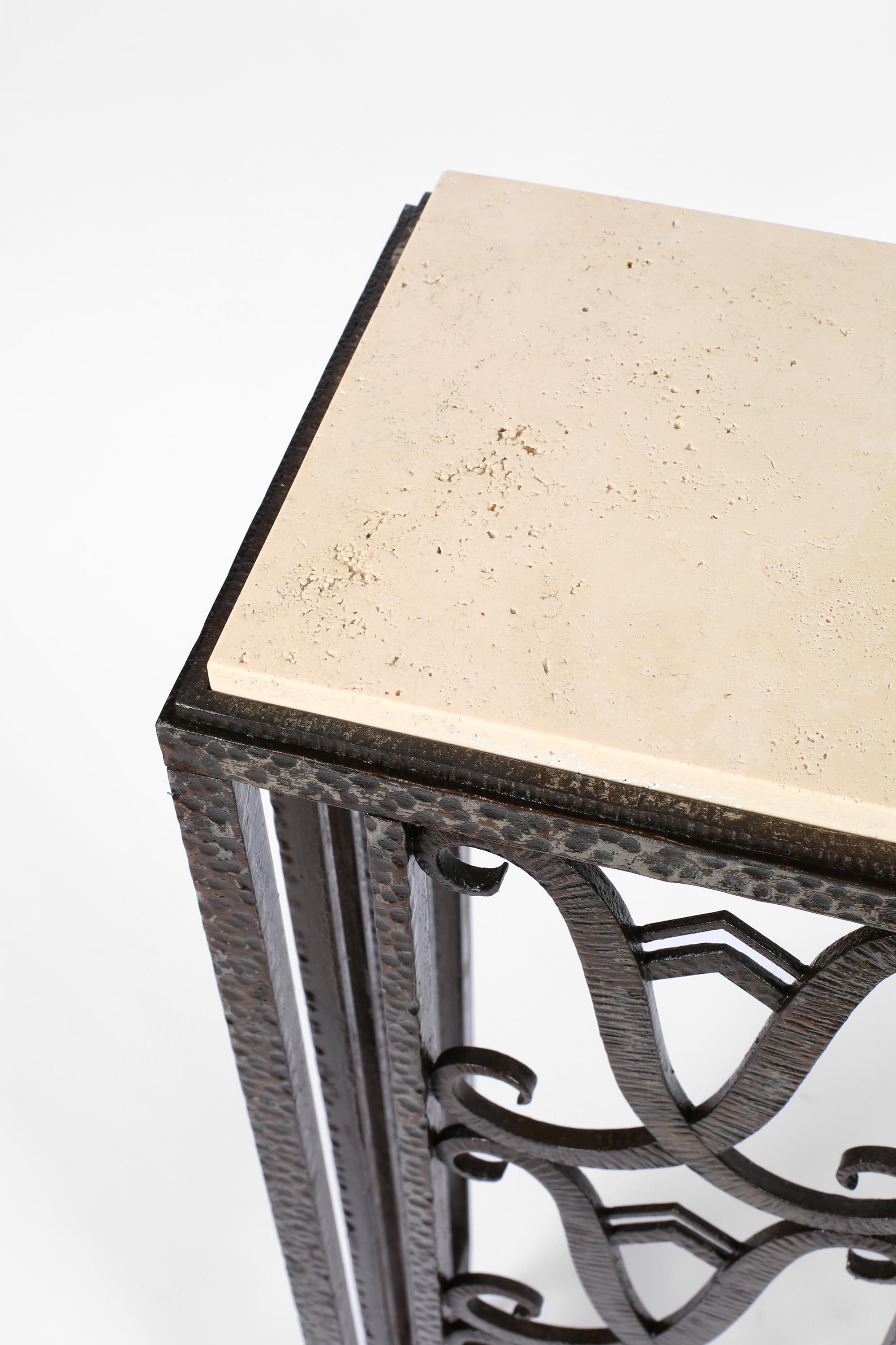 A fine Art Deco wall console table in patinated forged iron with limestone top. The frame decorated with differing hammer techniques - punctuated by scrolling motifs. Open on one side, allowing for use in a right hand corner, as a narrow entry