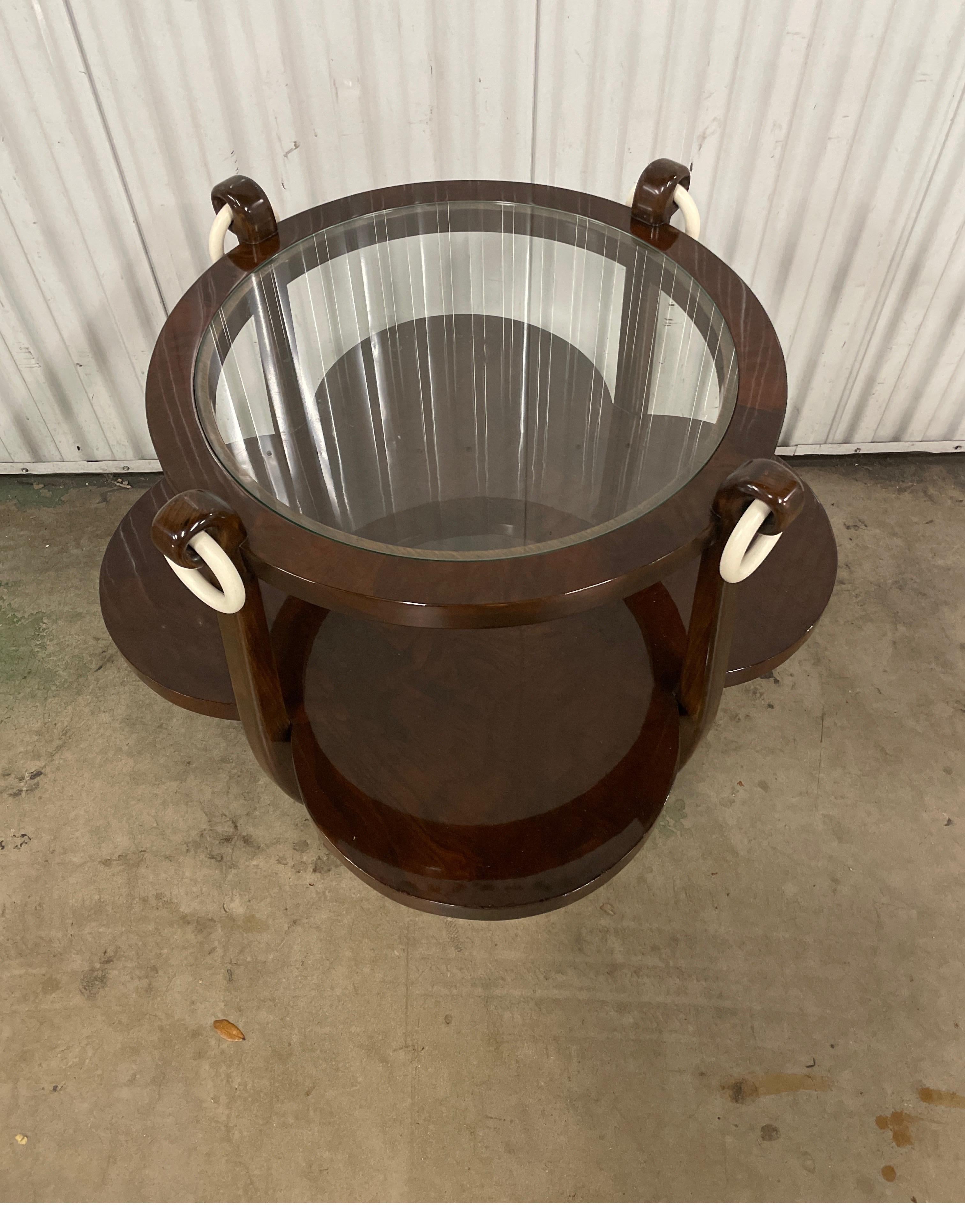 Art Deco Four Leaf Clover side table by Jules Leleu. The top is 22 inches in diameter with a glass insert. The bottom shelf is in the shape of a four leaf clover.