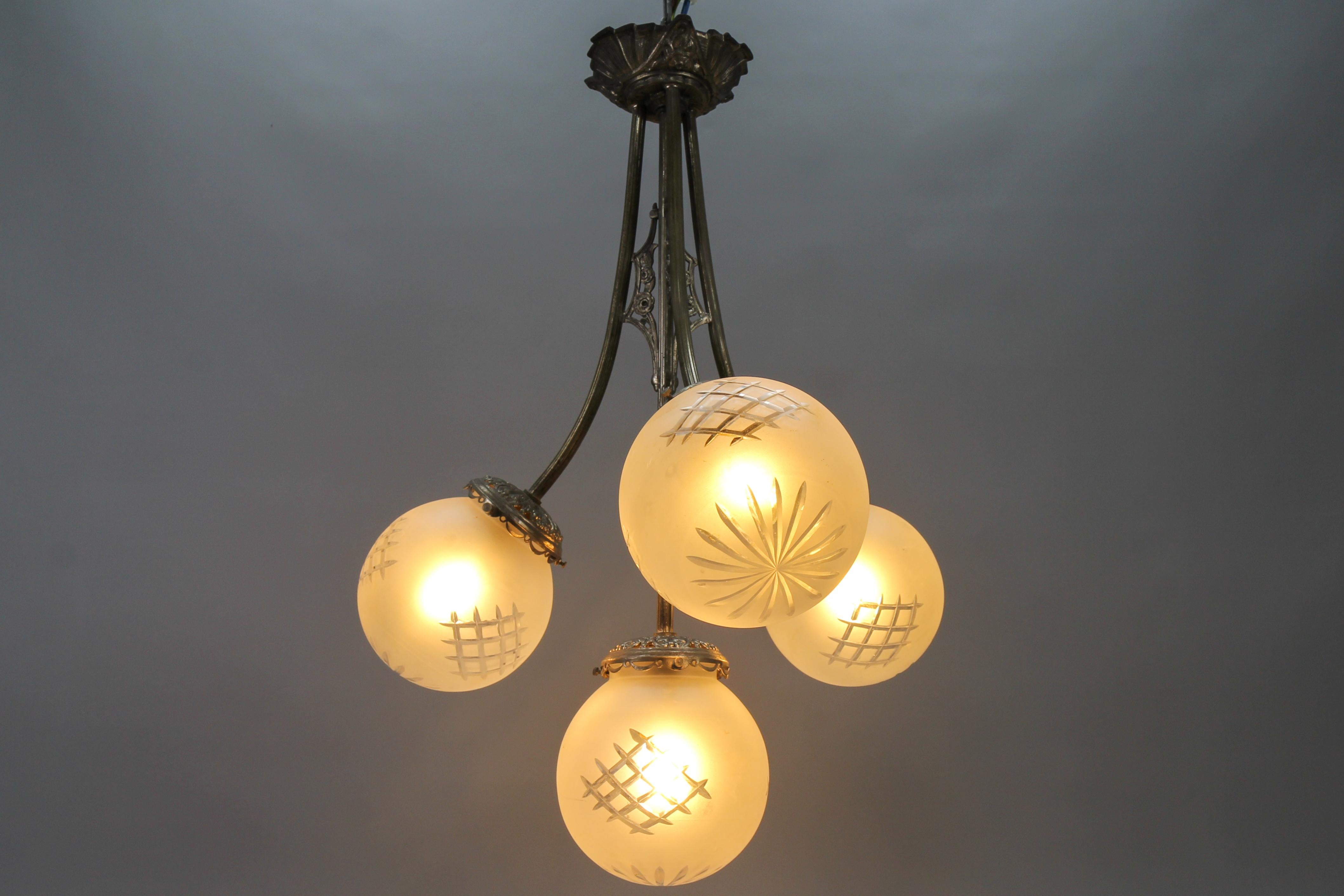 Mid-20th Century French Art Deco Four-Light Brass and Frosted Cut Glass Globes Pendant Chandelier For Sale