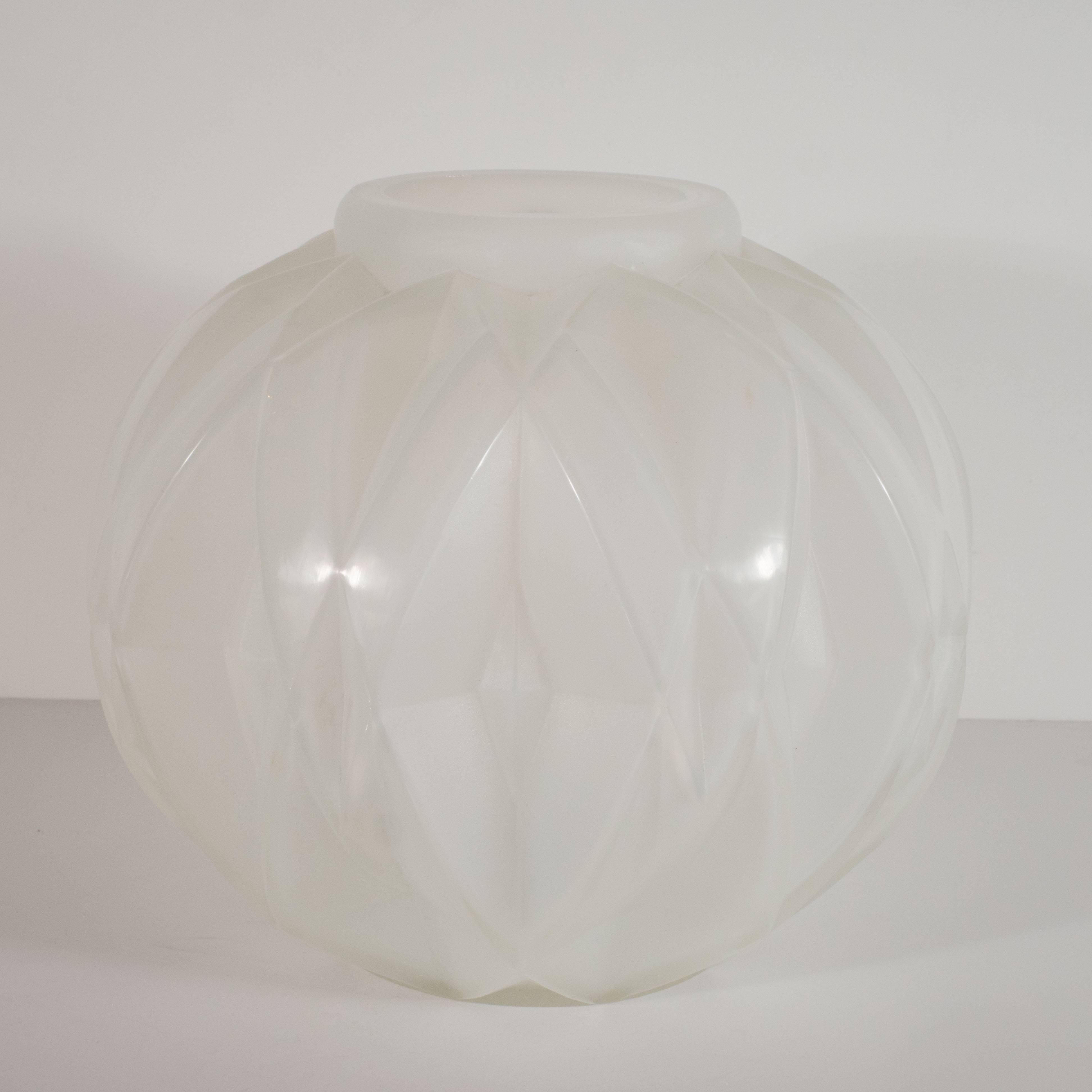 This refined glass vase was handblown by Andre Hunebelle one of the finest glass blowing studios of the period in France, circa 1930. It offers cubist diamond shaped geometric patterns etched in the glass throughout, and a gently expanding body that