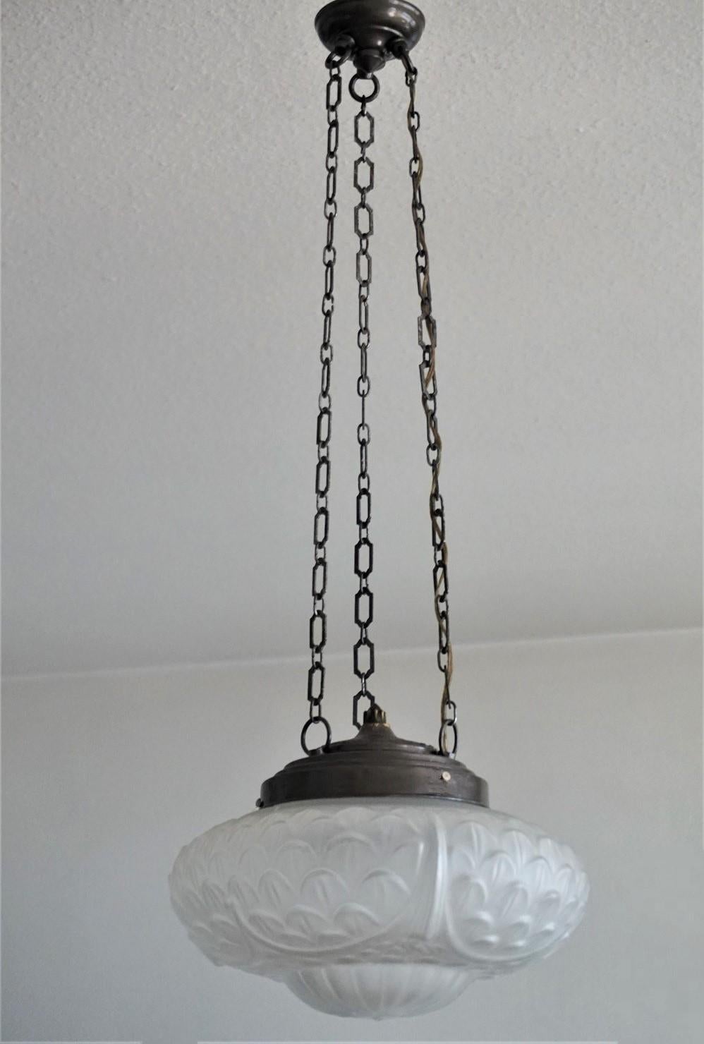 A lovely Art Deco frosted glass dome chandelier with brass fittings hanging from three brass chains connected to a circular canopy, France, early 1930s.
European wiring with one E14 light socket.
Measures: Height 30 in (76 cm)
Diameter 12 in (30