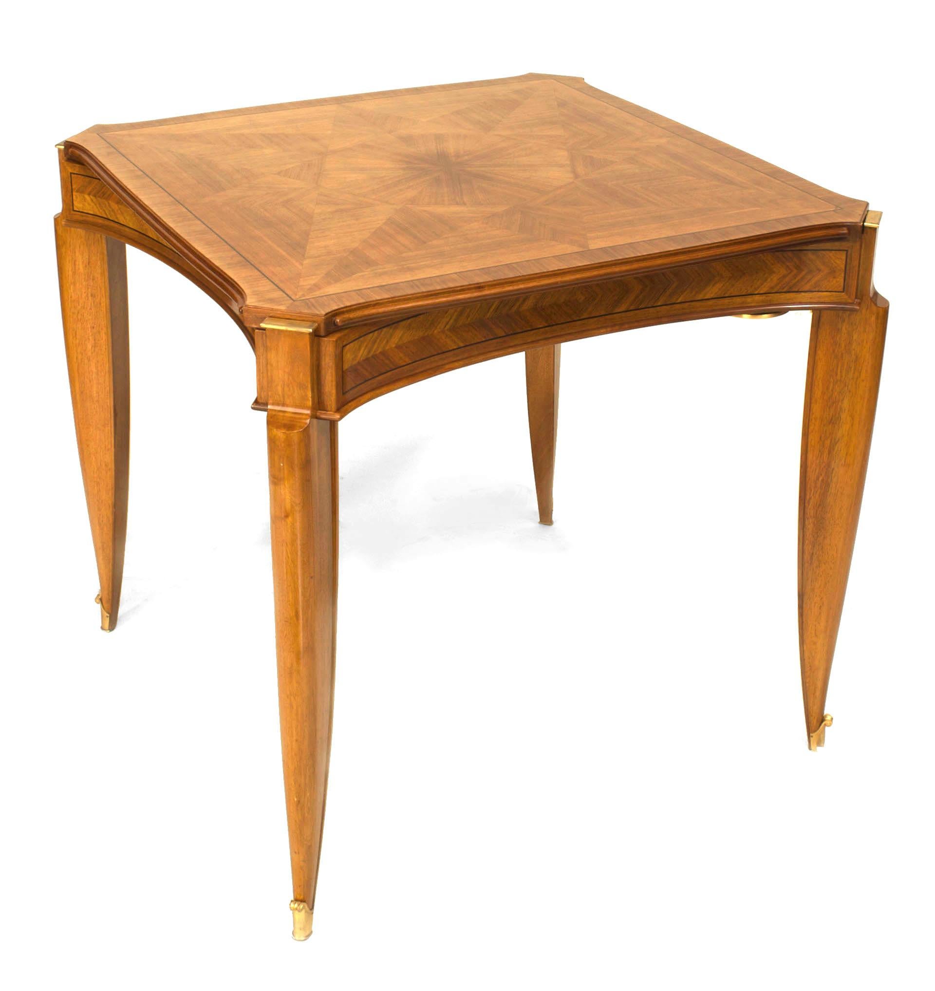 French Art Deco light mahogany square game table with a removable parquetry top & ebonized banded inlay trim over a concave apron with bronze trim & sabot. (JEAN PASCAUD) (Related item: 060628)
