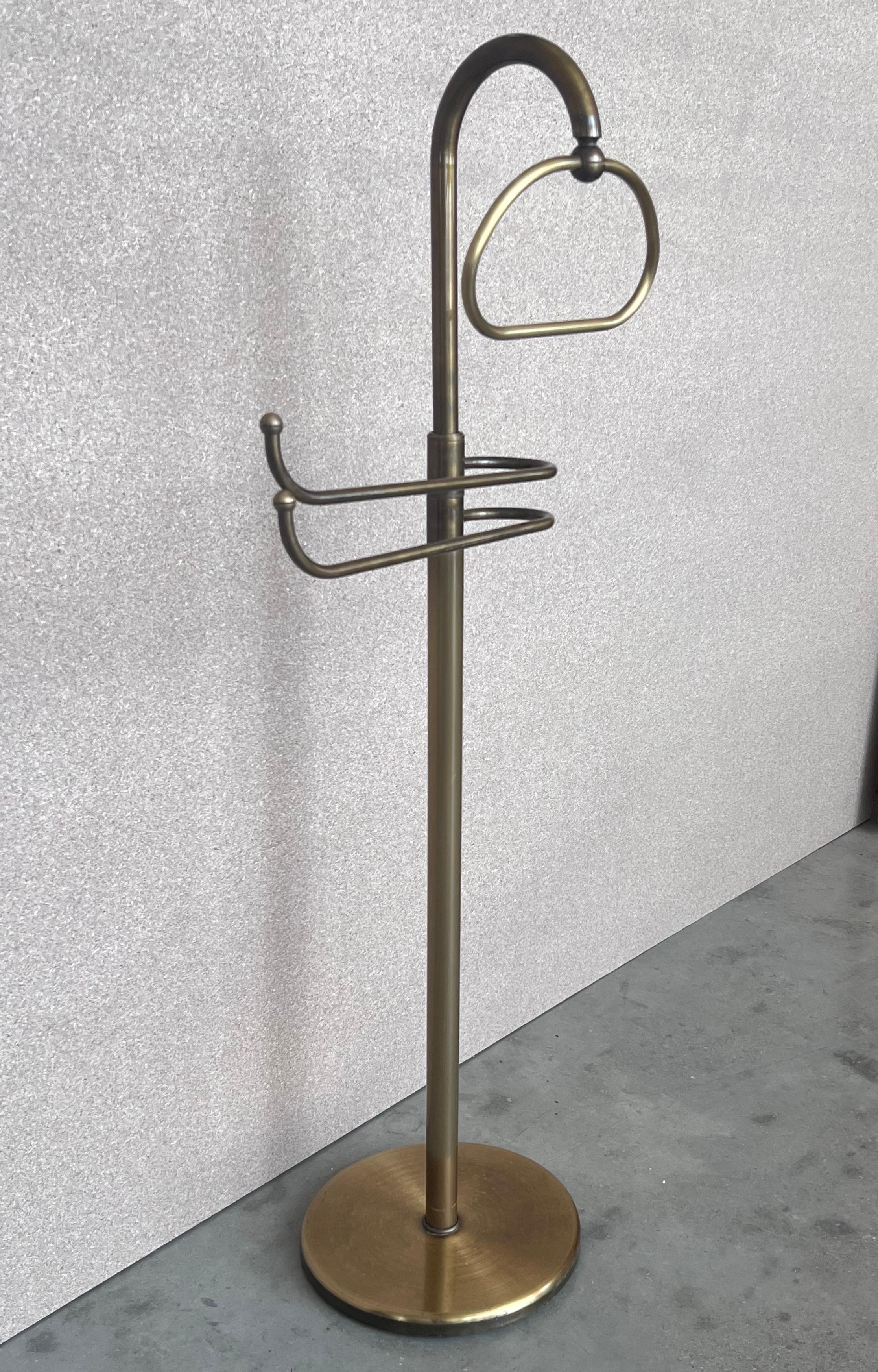 French Art Deco Gentleman’s floor standing brass suit hanger or dumb valet A very useful piece, the hanger or clothes stand is in brass and has a circular base, it has a small circular tray at the top for cufflinks etc. and a central brass rail for