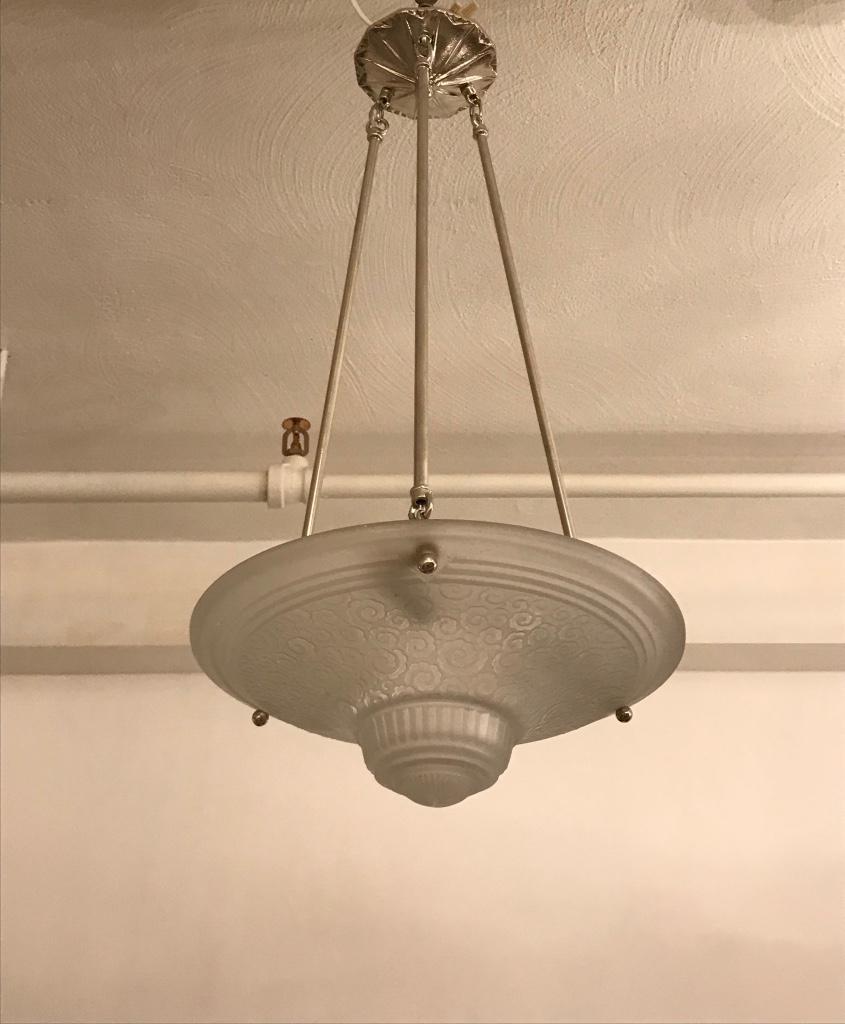 Stunning French Art Deco chandelier by Muller Frères Luneville. With beautiful clear frosted glass bowl with geometric motif. Held by three nickel-plated metal rods and matching ceiling plate. Has been rewired for American use. Three candelabra
