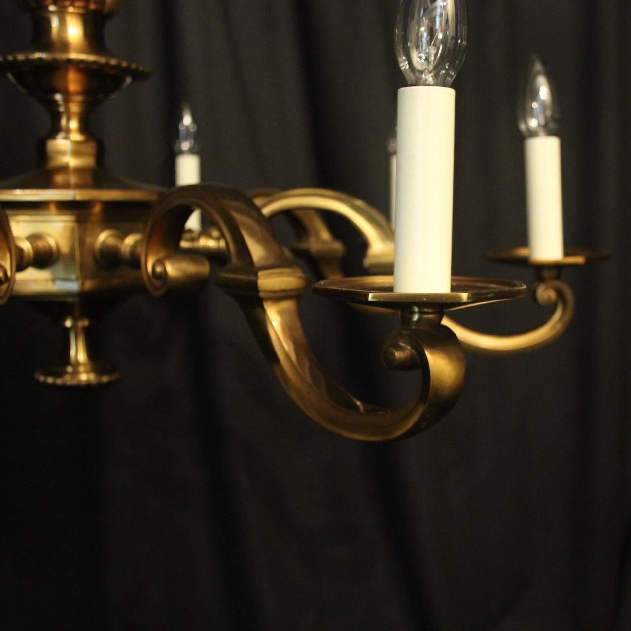 A large French gilded bronze Art Deco 8-light antique chandelier, the square gauge scrolling arms with octagonal bobeche drip pans, issuing from an sectional octagonal central column, having the original chain and ceiling rose with lovely original