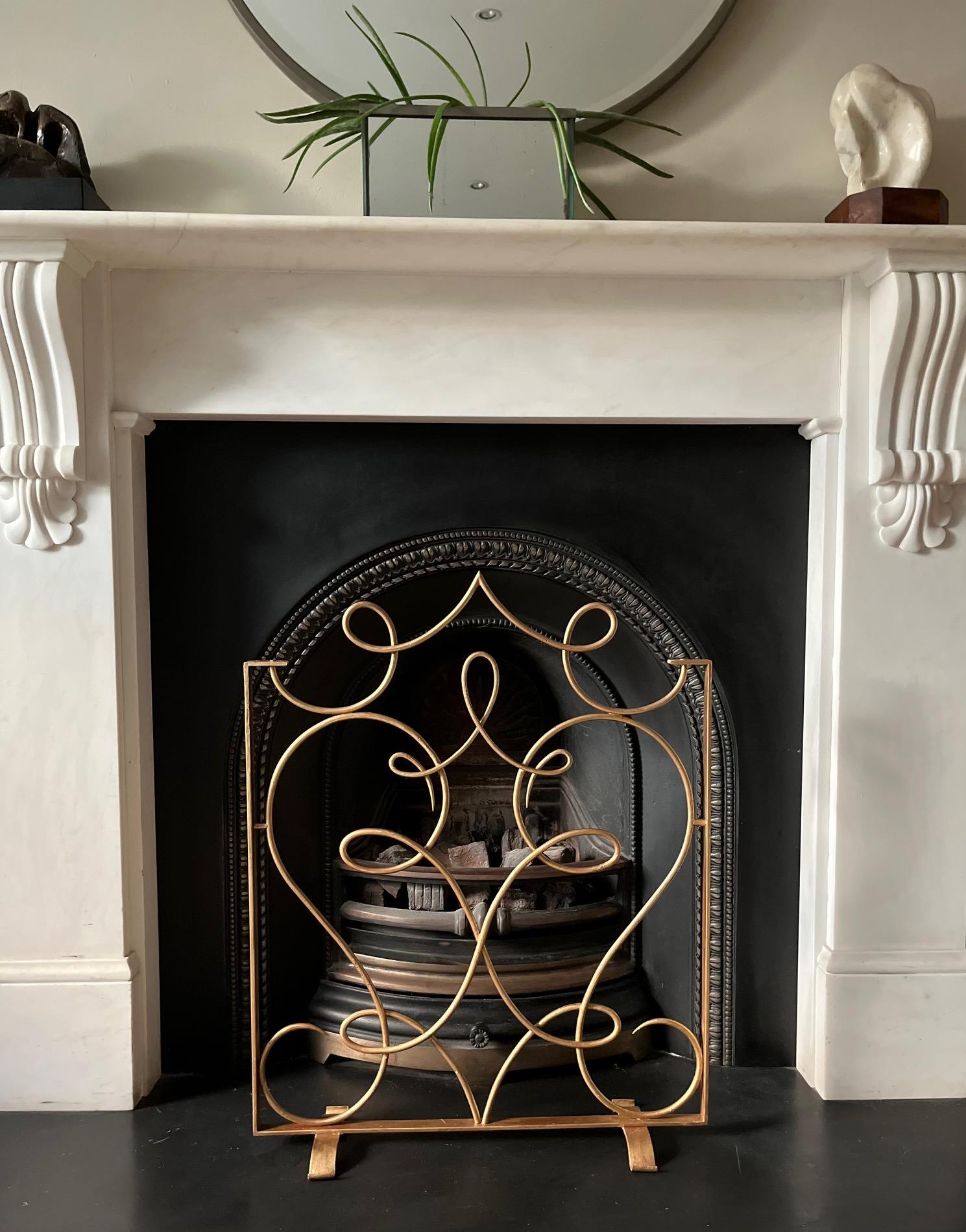 An elegant French 1930's wrought iron, regilded firescreen, fireguard. Highly decorative. Designed by the French designer Rene Prou.