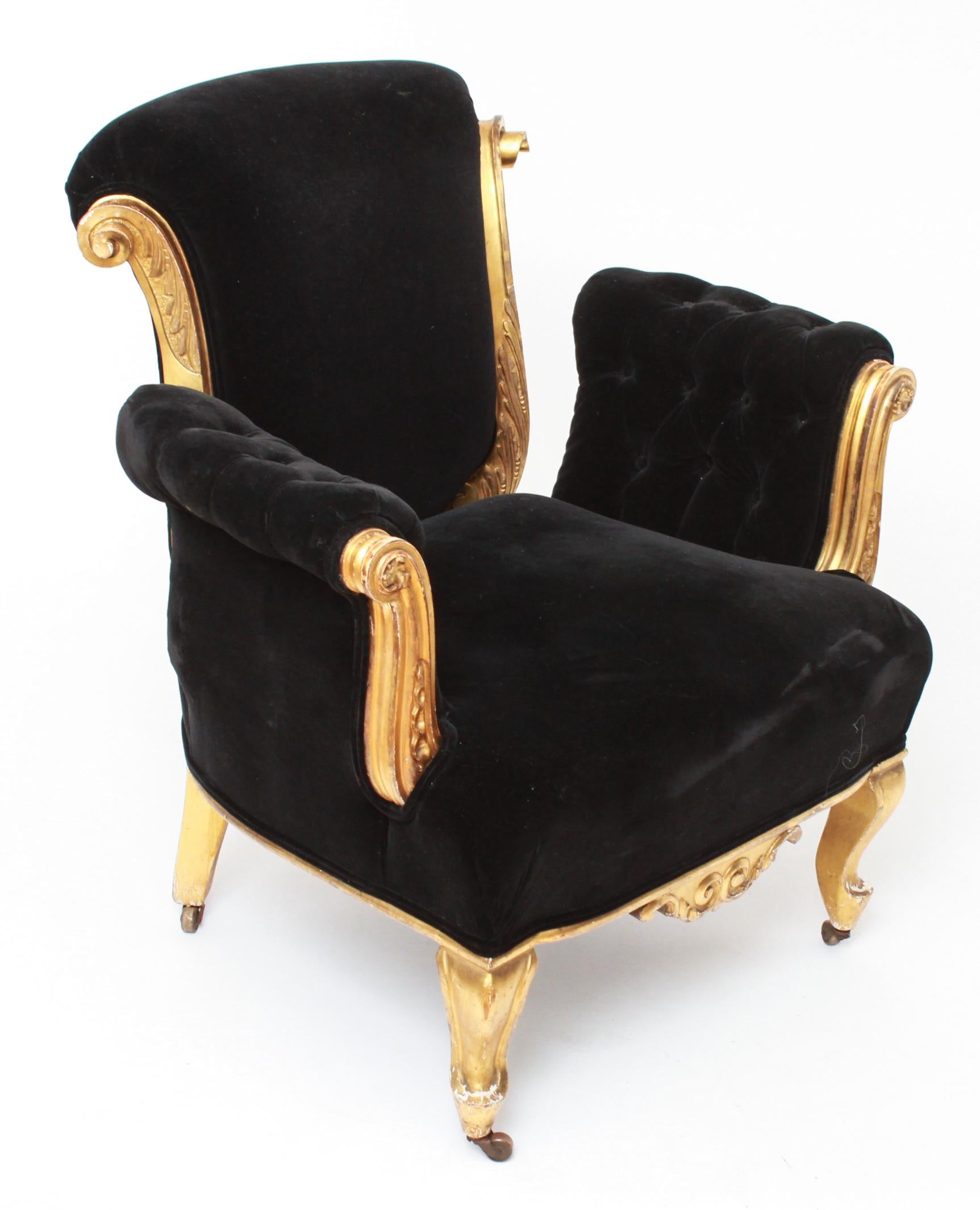 French Art Deco style gilt gesso wood with leaf and scroll motif armchair. The piece has black velvet upholstery with button-tufted arms.
In great vintage condition with age-appropriate wear and use. Mark on back seat of fabric.