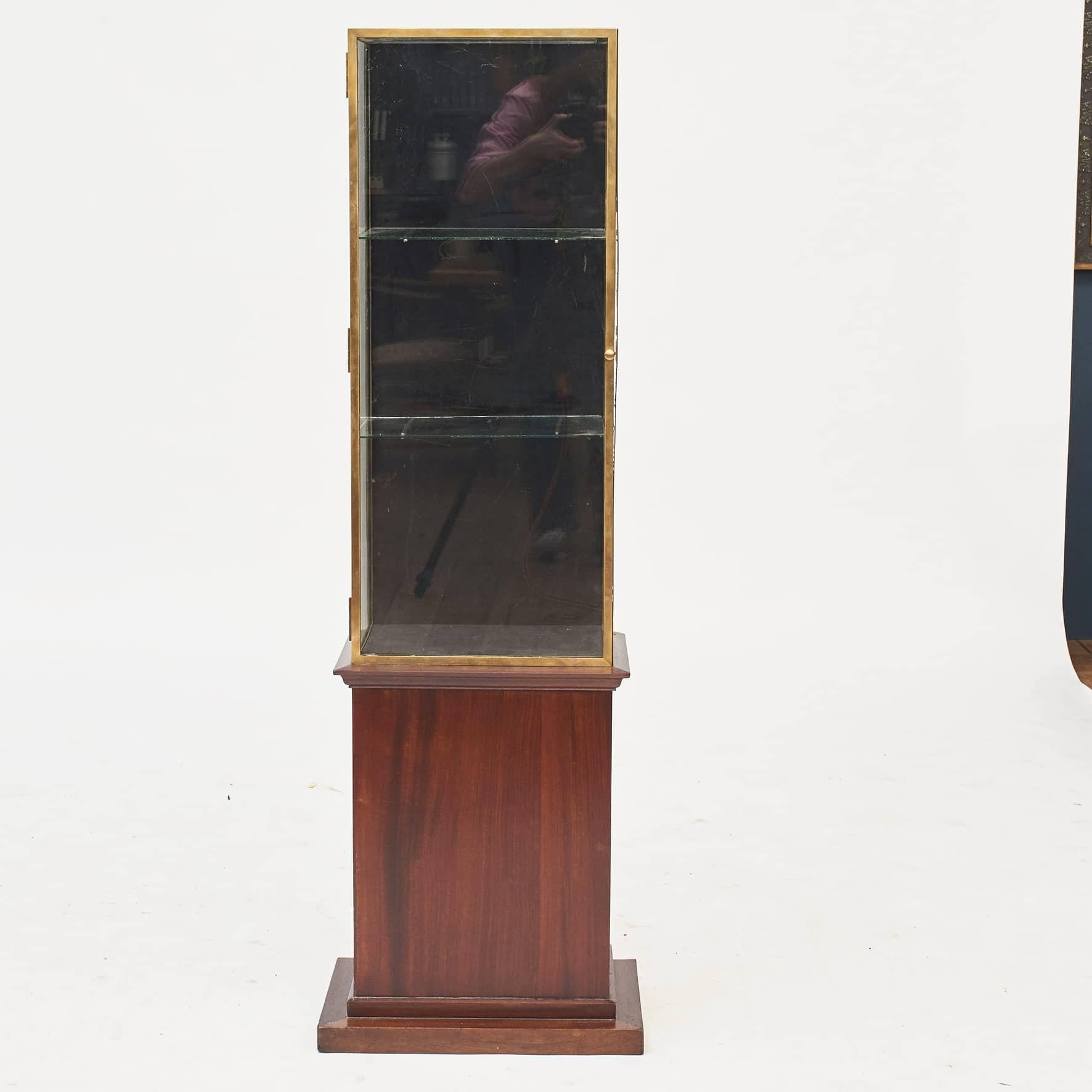 Art deco display case made from glass and brass on original mahogany stand.
The interior, back and bottom, is covered with black velvet. Glass shelves on original brackets.

France approx. 1920.
Measures:height total: 141 cm. Height of