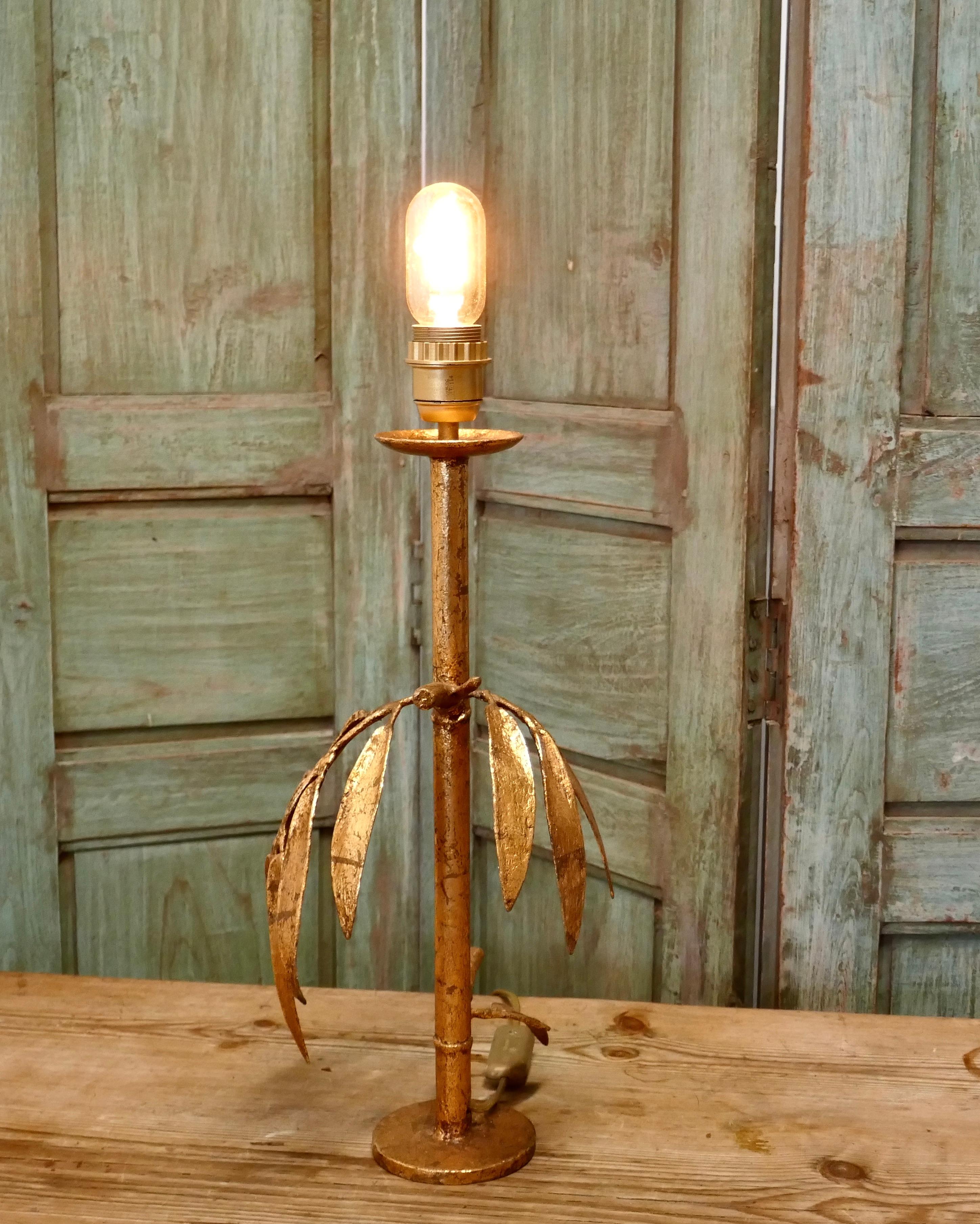 French Art Deco gold palm leaf table lamp

This is an exciting one-off piece, the lamp is not a very tall piece, but very attractive, the gold leaves of the palm tree hang out from the stem. 
I have shown the lamp with an Edison type bulb but