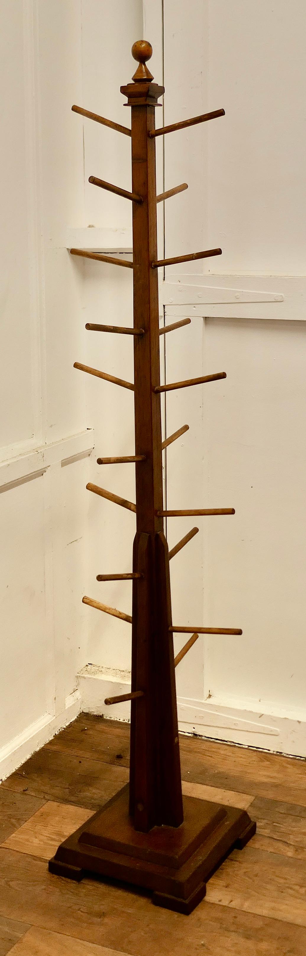 French Art Deco Golden Oak Window Display Stand

An Odeon style piece set on a stepped base and made in Golden Oak with 20 pegs to hang and display, the arms are set at a slight angle from the central column 
The Stand is 63” tall and 13”