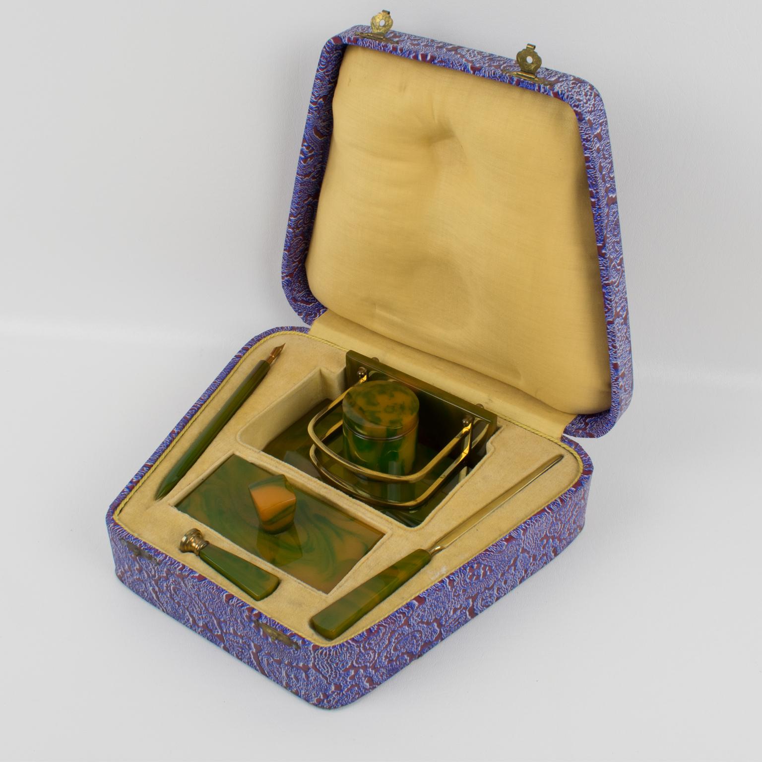 Stunning French Art Deco Bakelite desk accessories set. Beautiful green and orange marble Bakelite material, the color is also called green pepper cheese. Hardware is in gilded brass. Set is build of 6 pieces: letter opener, blotter, inkwell, wax