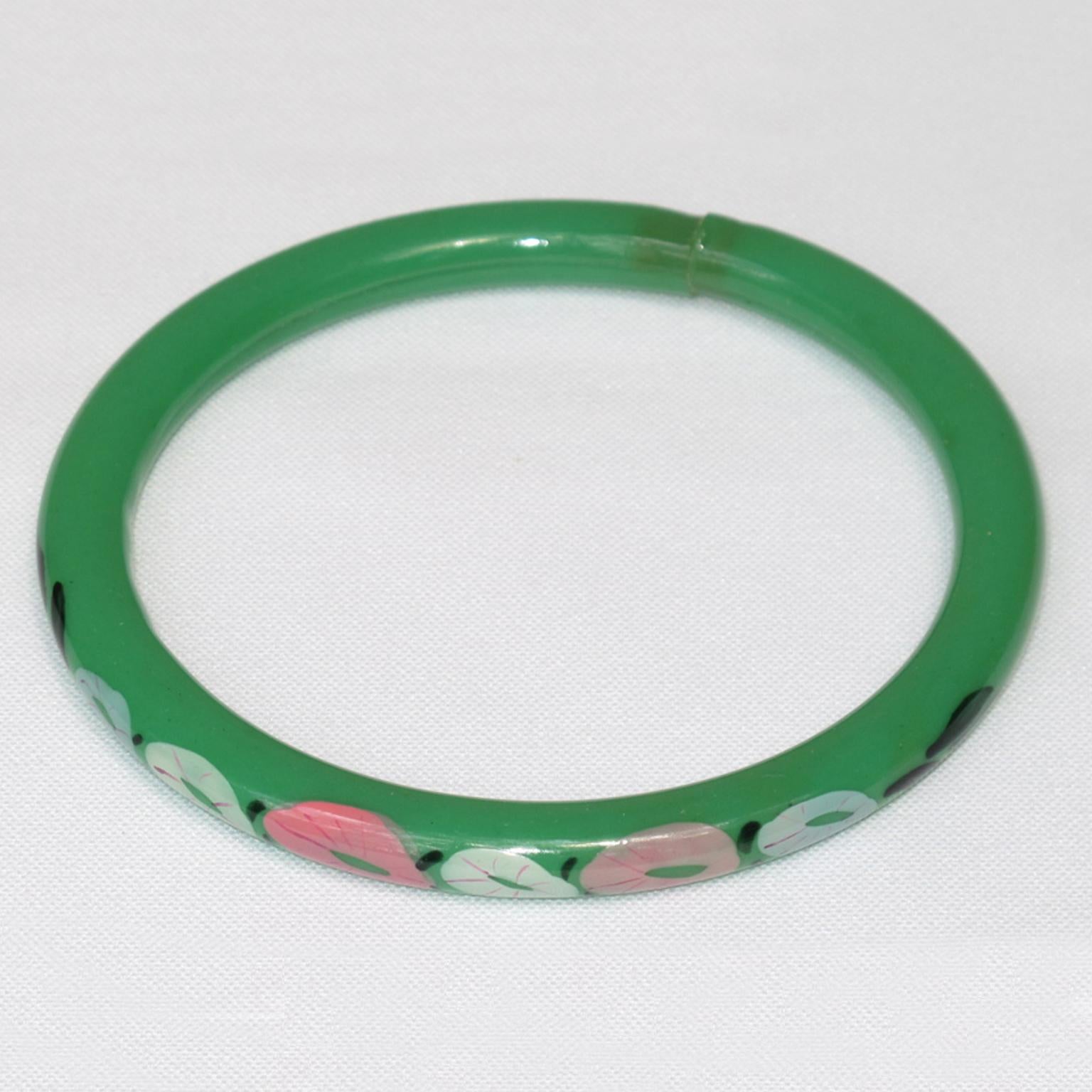 This is a lovely 1920s French Art Deco celluloid bracelet bangle. The piece features a light hollow tube shape with a floral design on one side of the bracelet. 
The hollow bracelet technique is an ancient technique applied to jewelry at the turn of