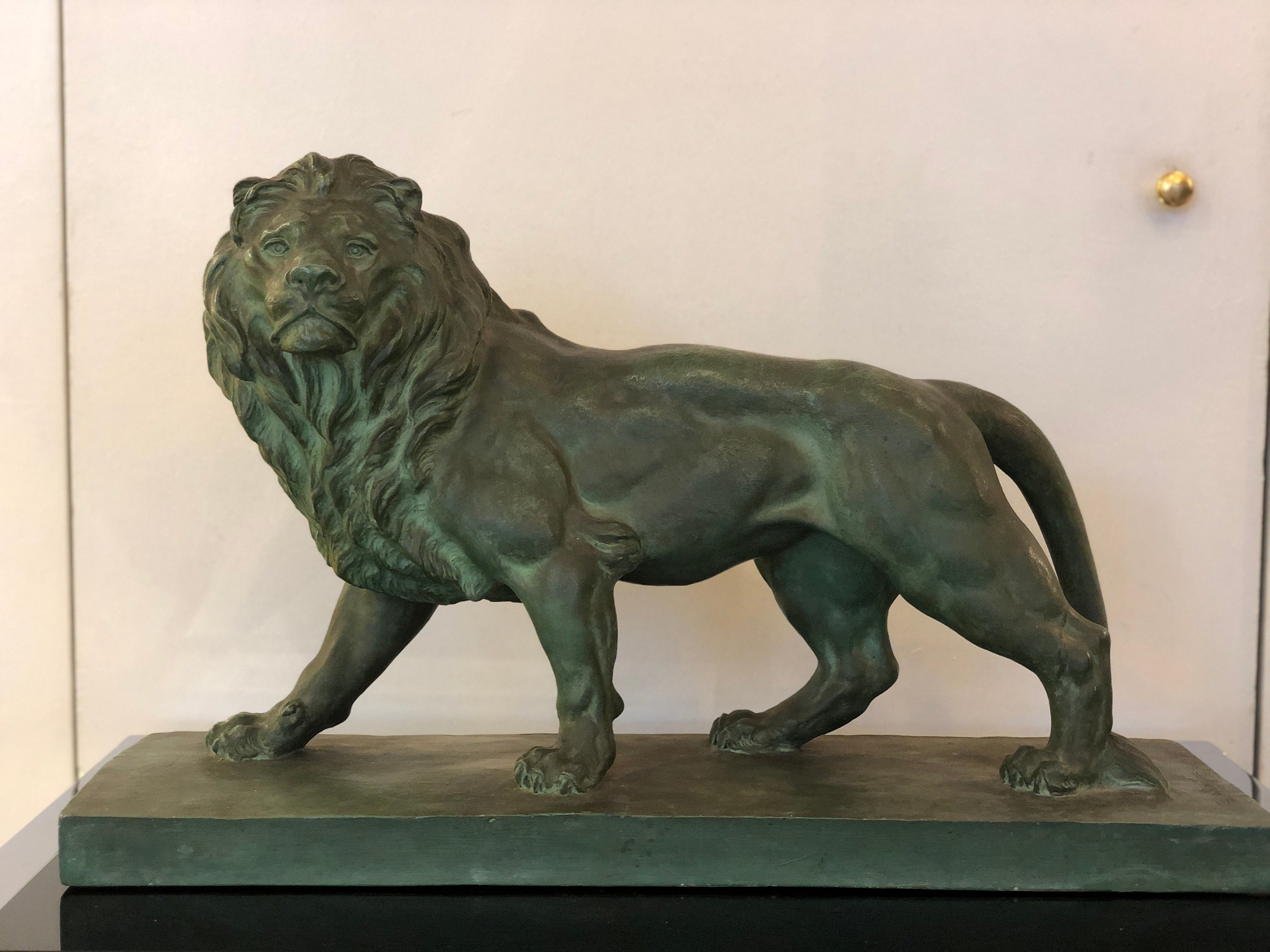 Art Deco green Terracotta lion animalier sculpture
This regal bearing lion is standing on his four legs staring at something in a very elegant position.
on the base of this sculpture there is a signature that we are currently studying.
The