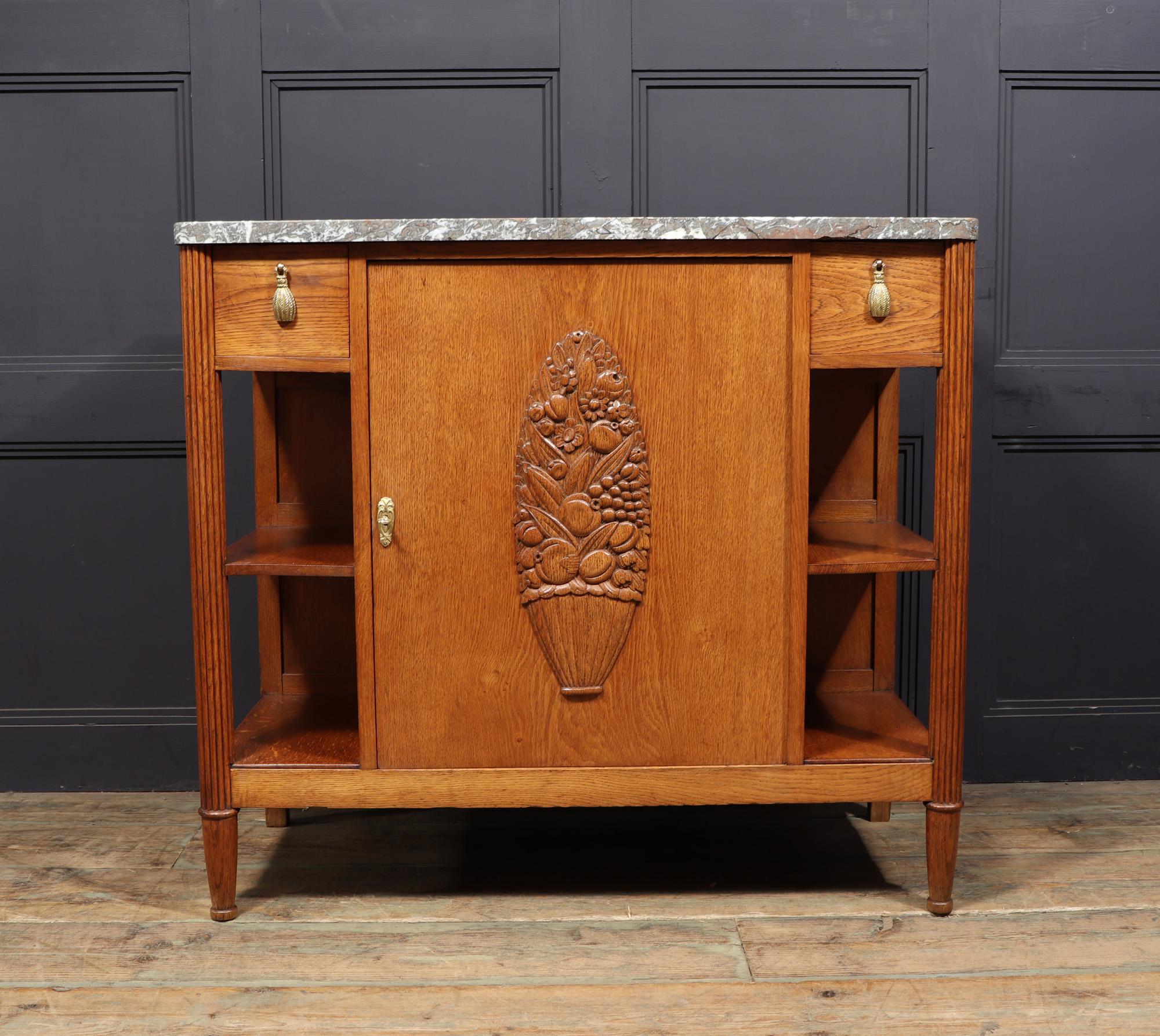 FRENCH ART DECO HALL CABINET
A stunning French Art Deco cabinet crafted from solid oak in the 1930s, inspired by the renowned Paul Follot. This exquisite piece features a central lockable cupboard door adorned with intricate floral carvings in a