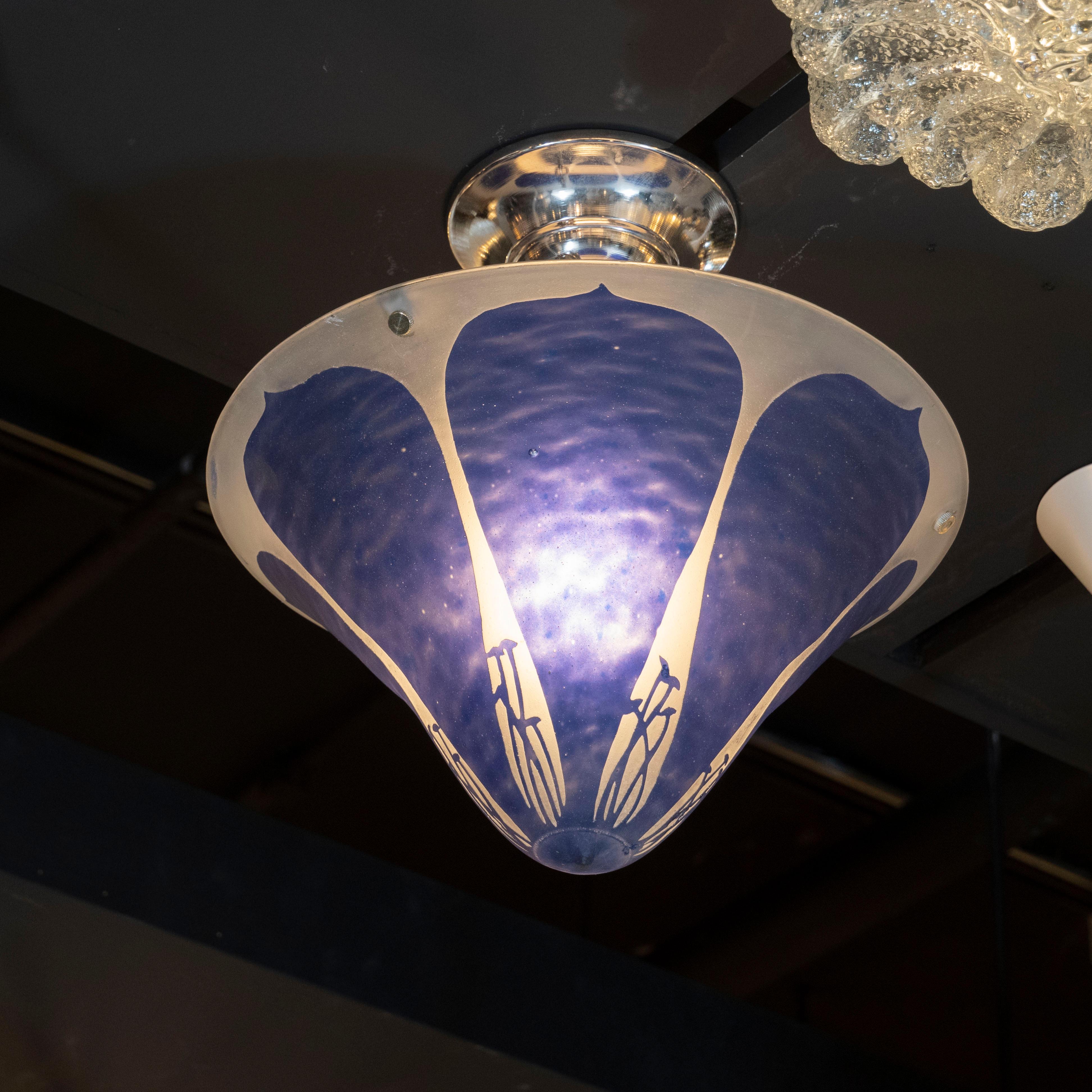 This elegant Art Deco chandelier was hand blown by the celebrated lighting studio Degué in France, circa 1925. Equally stunning from all angles, the chandelier features a conical shape resembling a pitched mushroom cap with tear drop forms in
