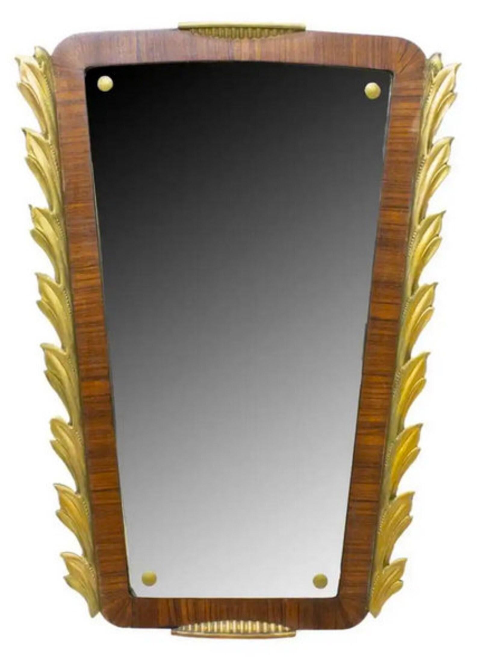 A fabulous period, Art Deco mirror with beautiful patina. Born in France during the early 20th century, having hand carved and gilded foliate trim, exotic figured wood inlaid bezel, holding a thin beveled mirror.

Dimensions (approx):
24.25