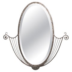 French Art Deco hand wrought nickeled iron oval mirror w/ linear & scroll detail