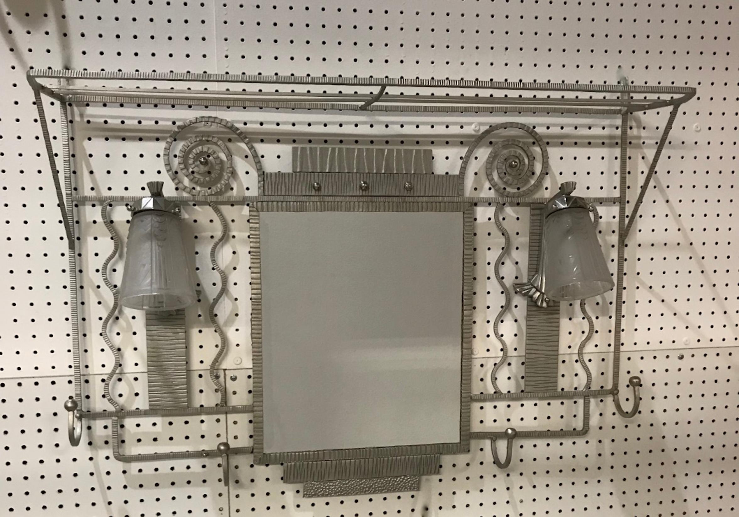 French Art Deco coat rack with pair signed of Muller Frères Luneville sconces. With two clear frosted glass shades having geometric motifs. Held by a polished nickel design frame. Features a central beveled mirror and hat rack with beautiful Deco