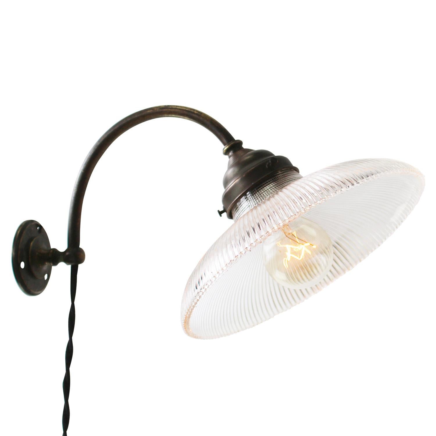 French wall lamp, Sconce
Clear Holophane glass shade
Brass wall piece and arm

2 meter cotton flex, with plug and switch

diameter brass wall mount: 6.5 cm / 2.56”

Weight: 1.00 kg / 2.2 lb

Priced per individual item. All lamps have been made