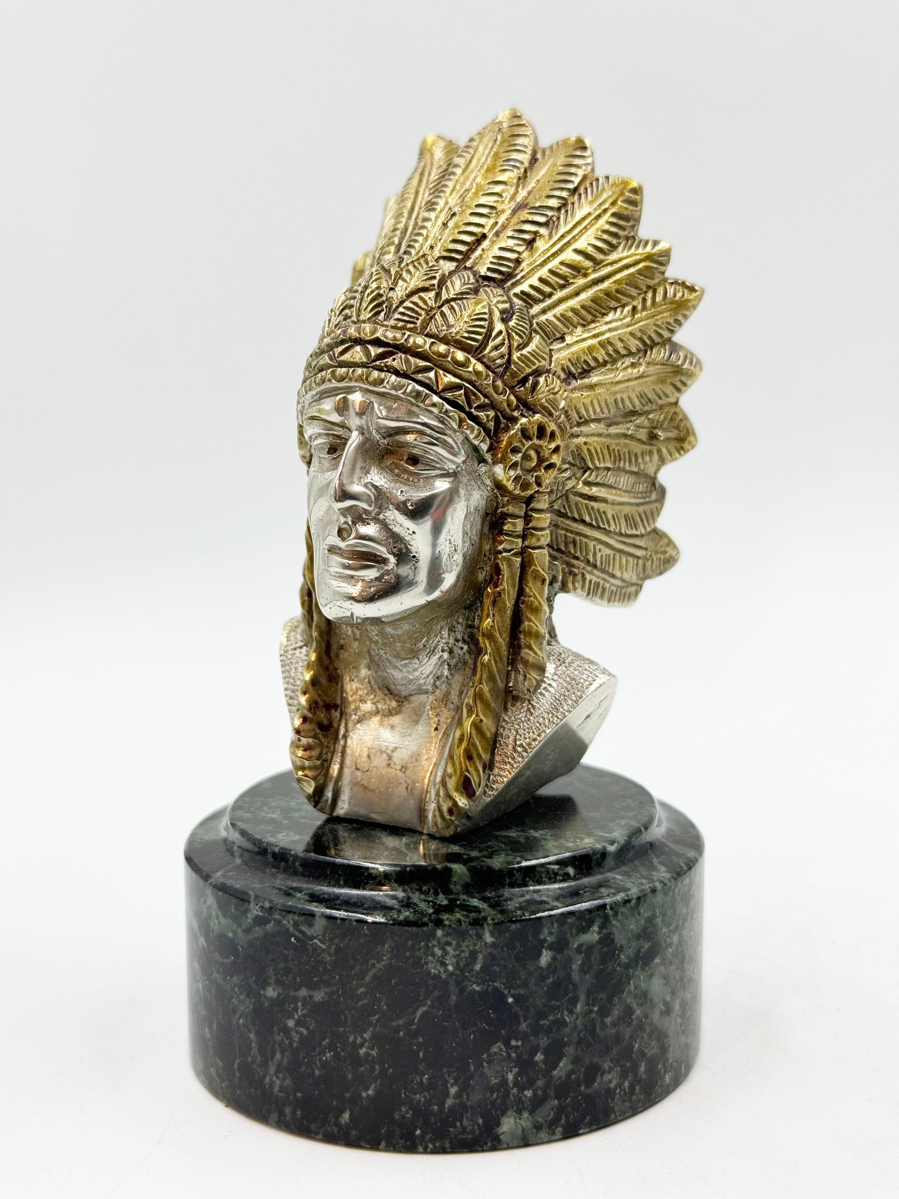 French Art Deco Indian Car Mascot by Ruffoni, 1930 
Car radiator cap mascot depicting an Indian chief. 
Artist/Maker: Ruffony Signature/Marks: Ruffony 
Style: Art Deco 
Material: Bronze with silver patina 
Date: 1930 Origin: France 
Condition: Good