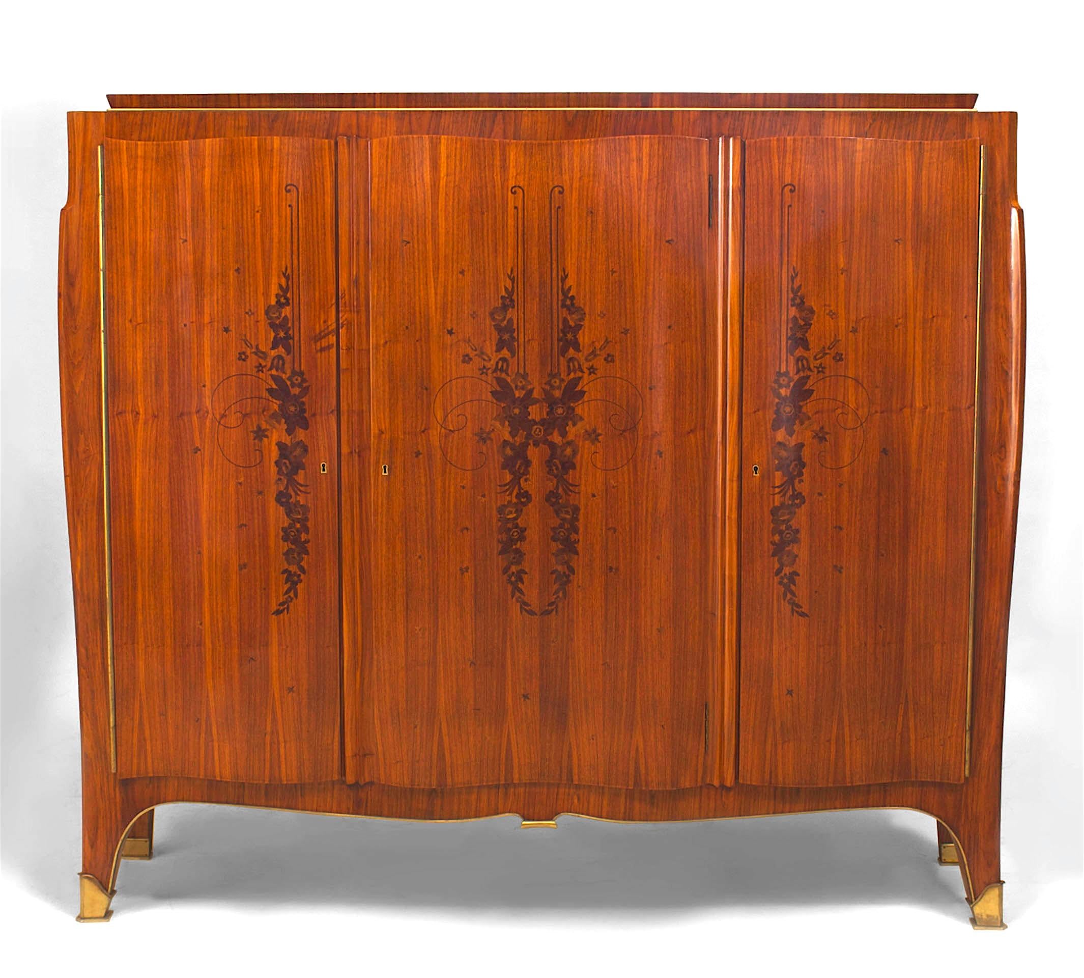 French Art Deco three door cabinet inlaid with rosewood floral decorations and fitted with gilt bronze sabots (attributed to LELEU).
