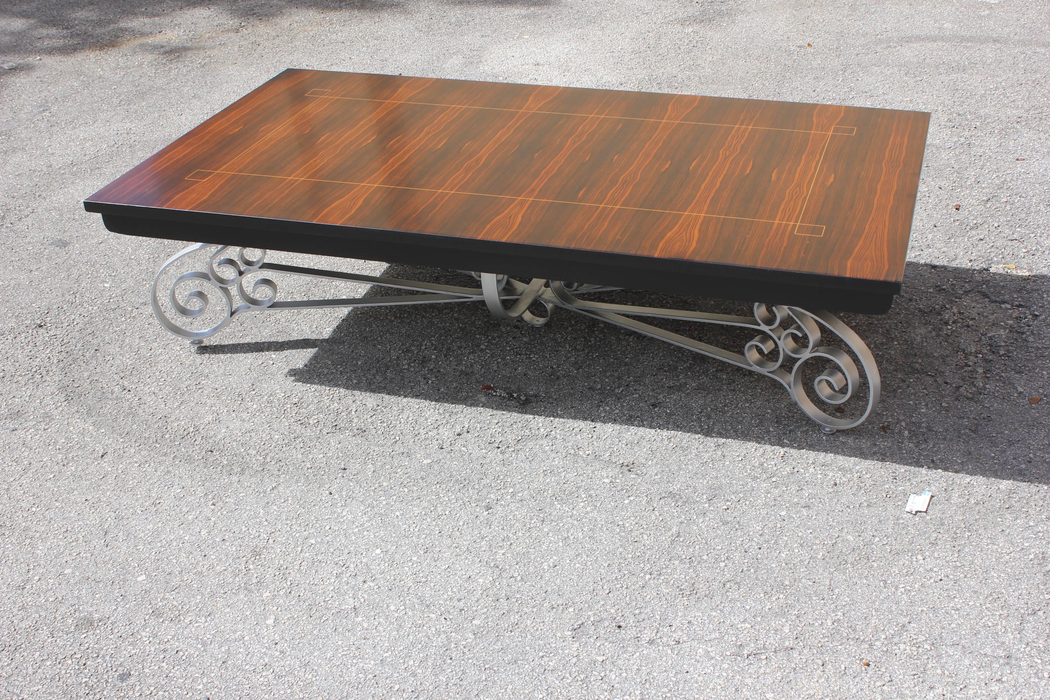 Monumental French Art Deco beautiful iron base and detail, exotic Macassar ebony coffee table, circa 1940s, in perfect condition. Size 63 W x 16. 38 H x 35.13 D.