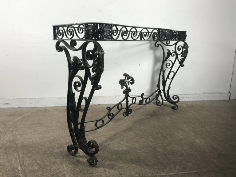 Stylized Art Deco console table base. Decorative leaf and flower bouquet. Wrought iron scrolling base in the style of Raymond Subes, hand delivery avail to New York City or anywhere en route from Buffalo NY.