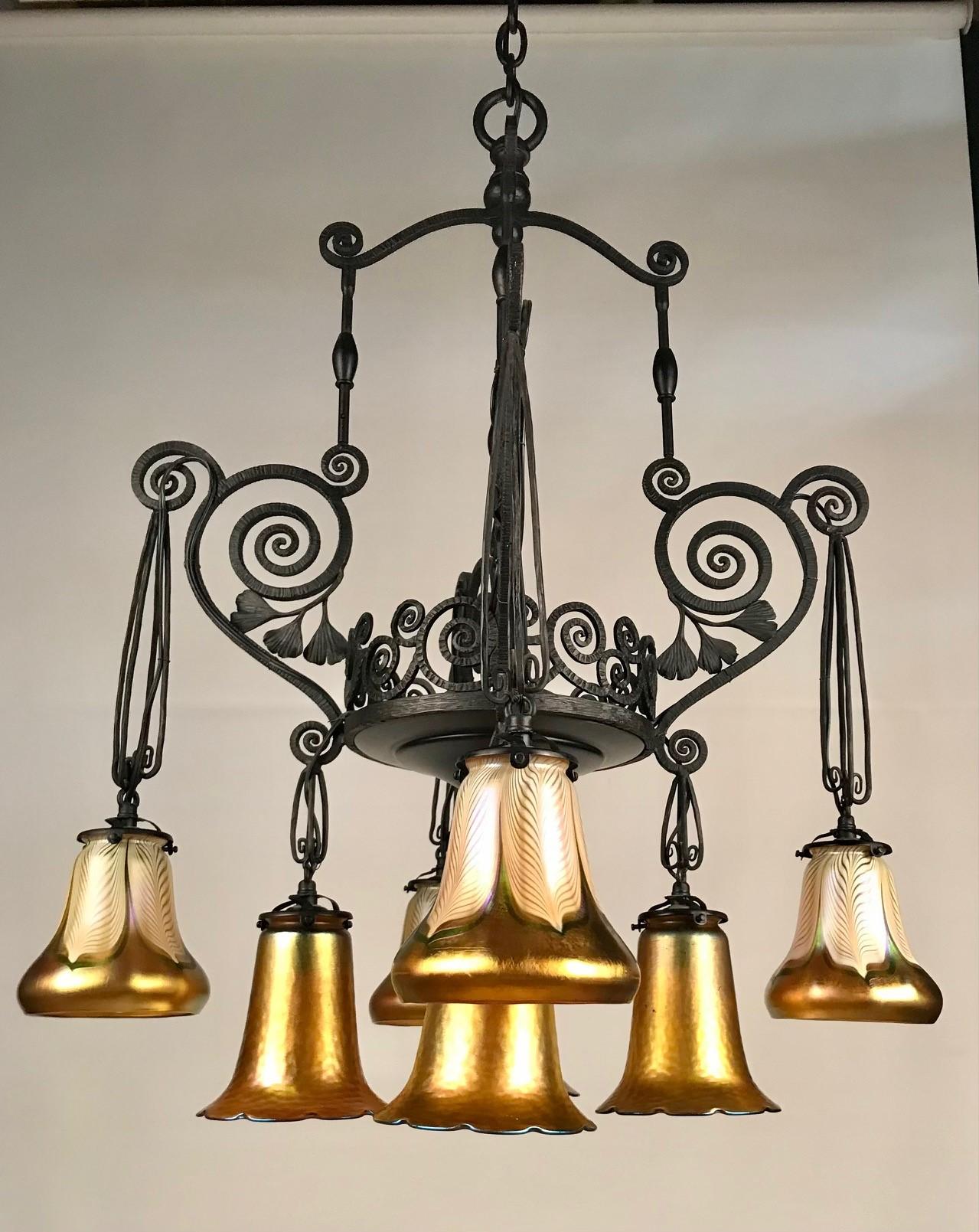 French Art Deco Iron Eight-Light Chandelier with Quezal Shades In Good Condition In Montreal, QC
