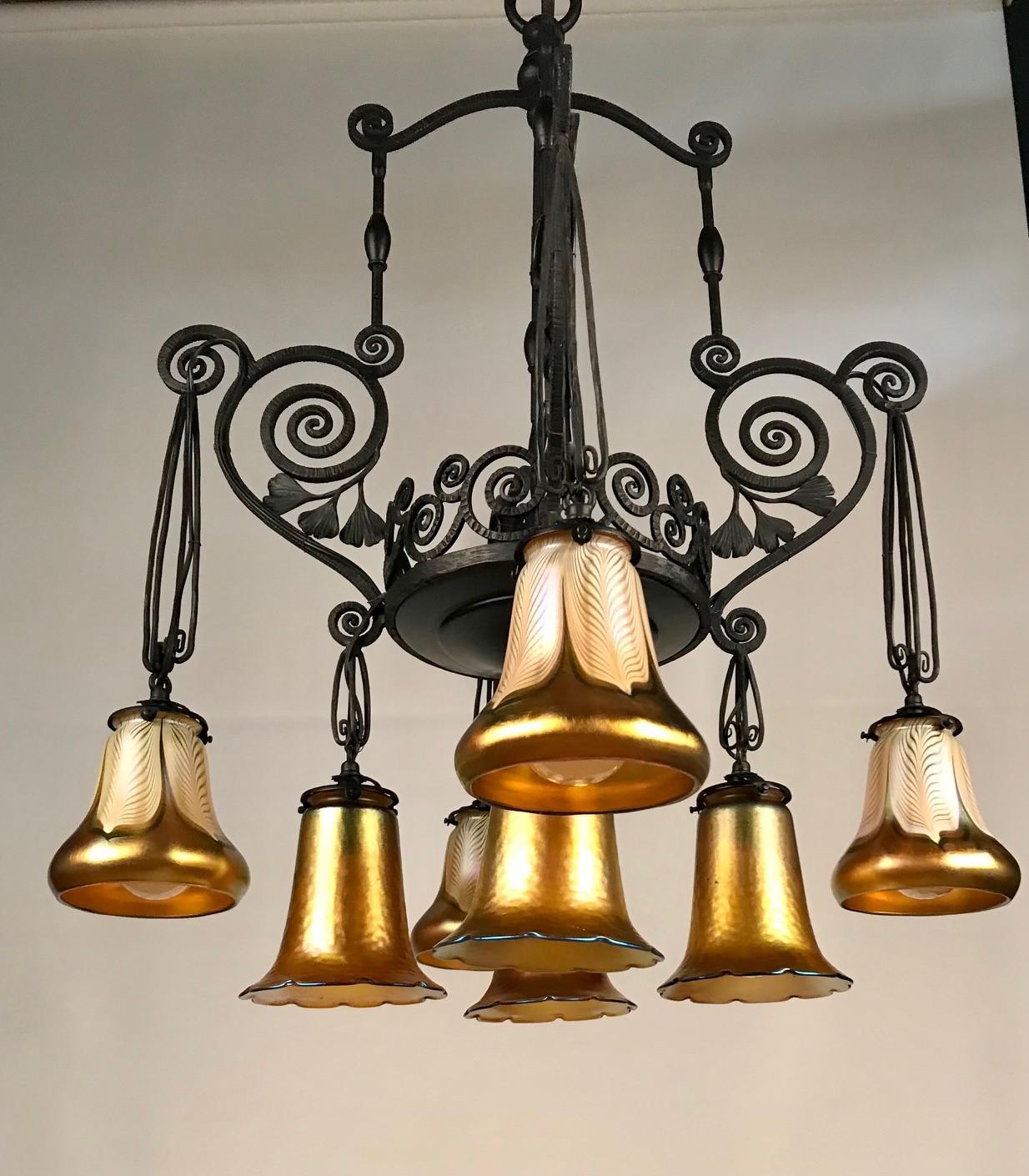 Early 20th Century French Art Deco Iron Eight-Light Chandelier with Quezal Shades