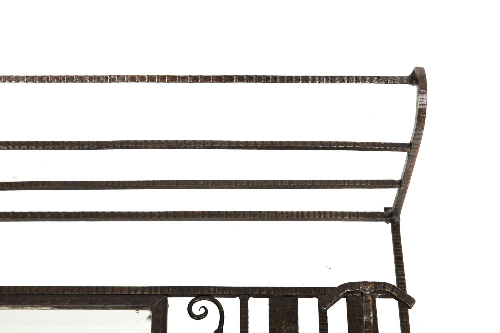 ART DECO PERIOD WROUGHT-IRON MIRRORED HALL-RACK
Circa 1930s  with 4 coat hooks and a top shelf
Item # 306CWT14P 

A very cool hallway mirror designed with an eye to nature out of wrought-iron, the geometrical and angular body is interlaced with