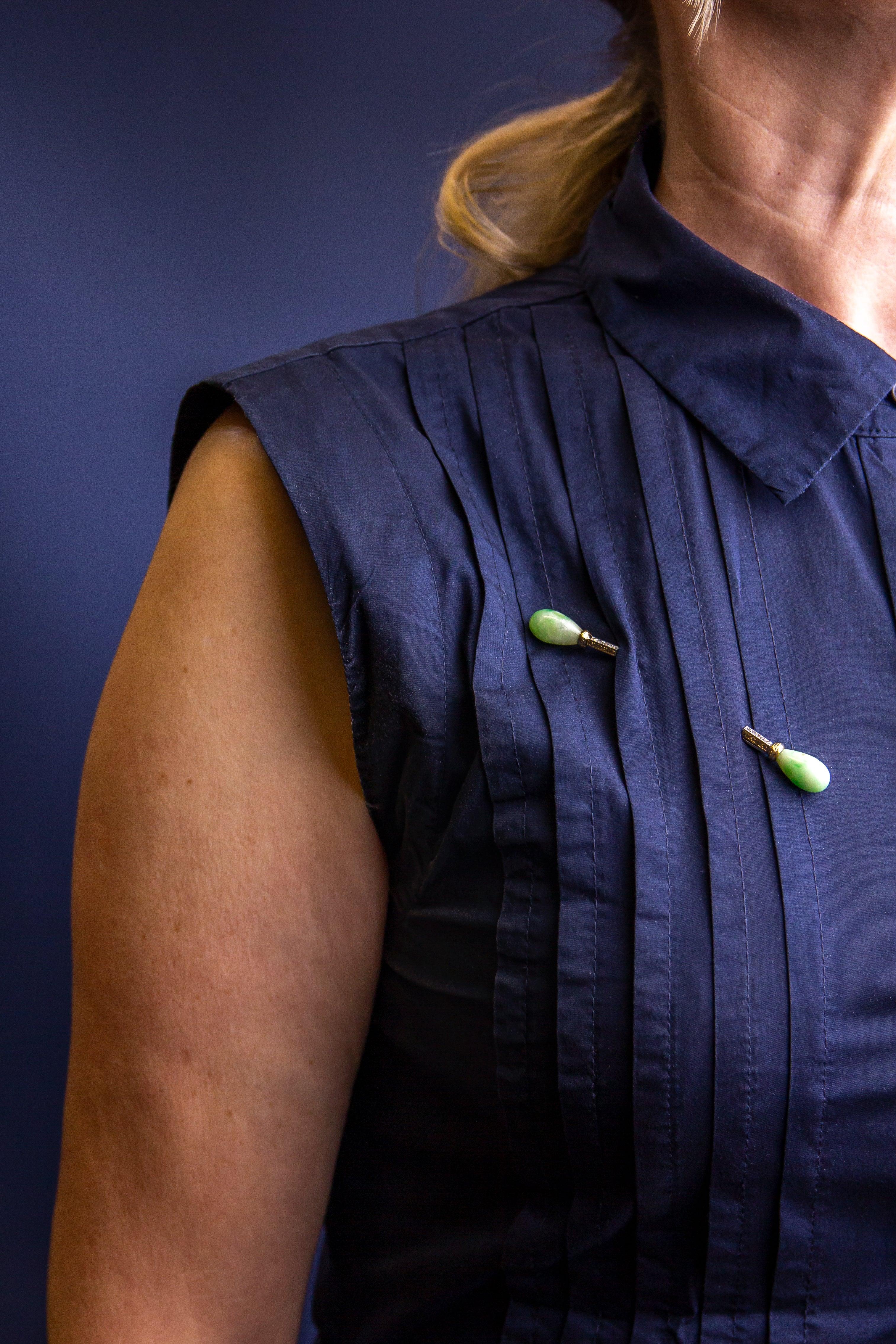 This wonderful French jabot pin dates to the Art Deco period during which these pins became a popular jewel. The piece is double ended and to each end features a piece of drop shaped jadeite jade which has been classed as 'opaque mottled green and